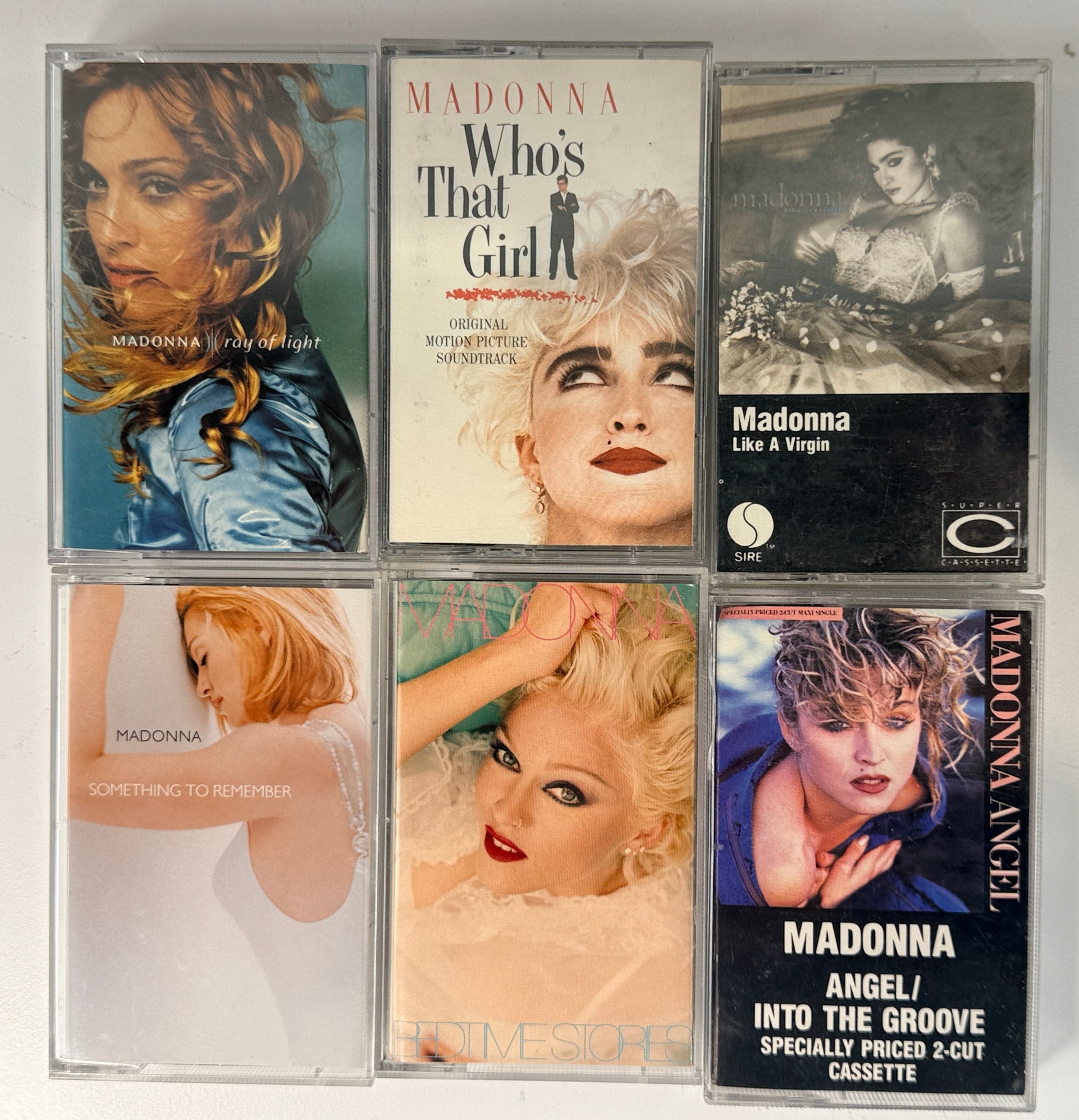 Vintage Madonna cassette tape lot featuring 12 albums from the 80s and 90s including Like a Virgin, True Blue, and Ray of Light, complete with cases.