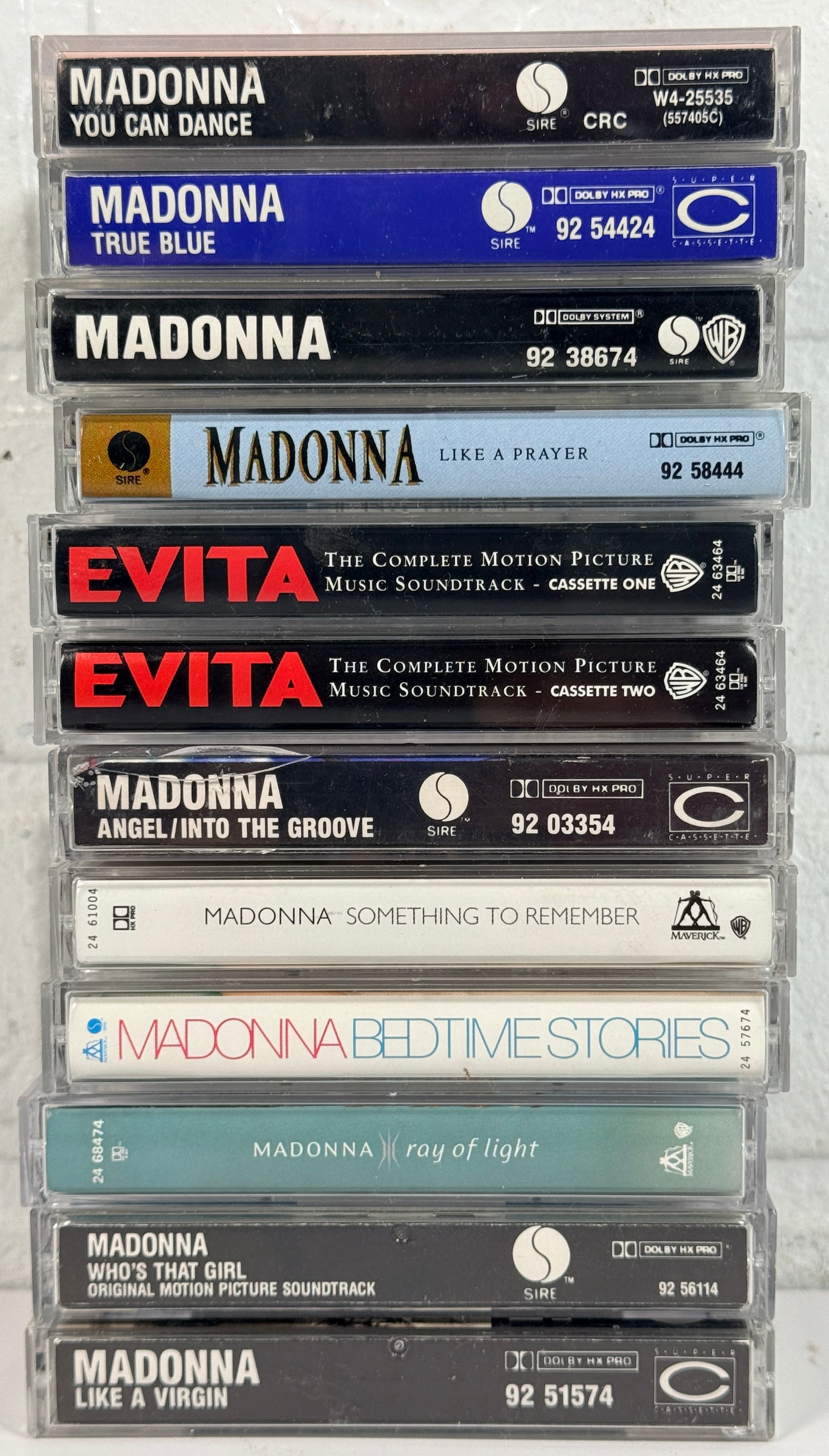 Vintage Madonna cassette tape lot featuring 12 albums from the 80s and 90s including Like a Virgin, True Blue, and Ray of Light, complete with cases.