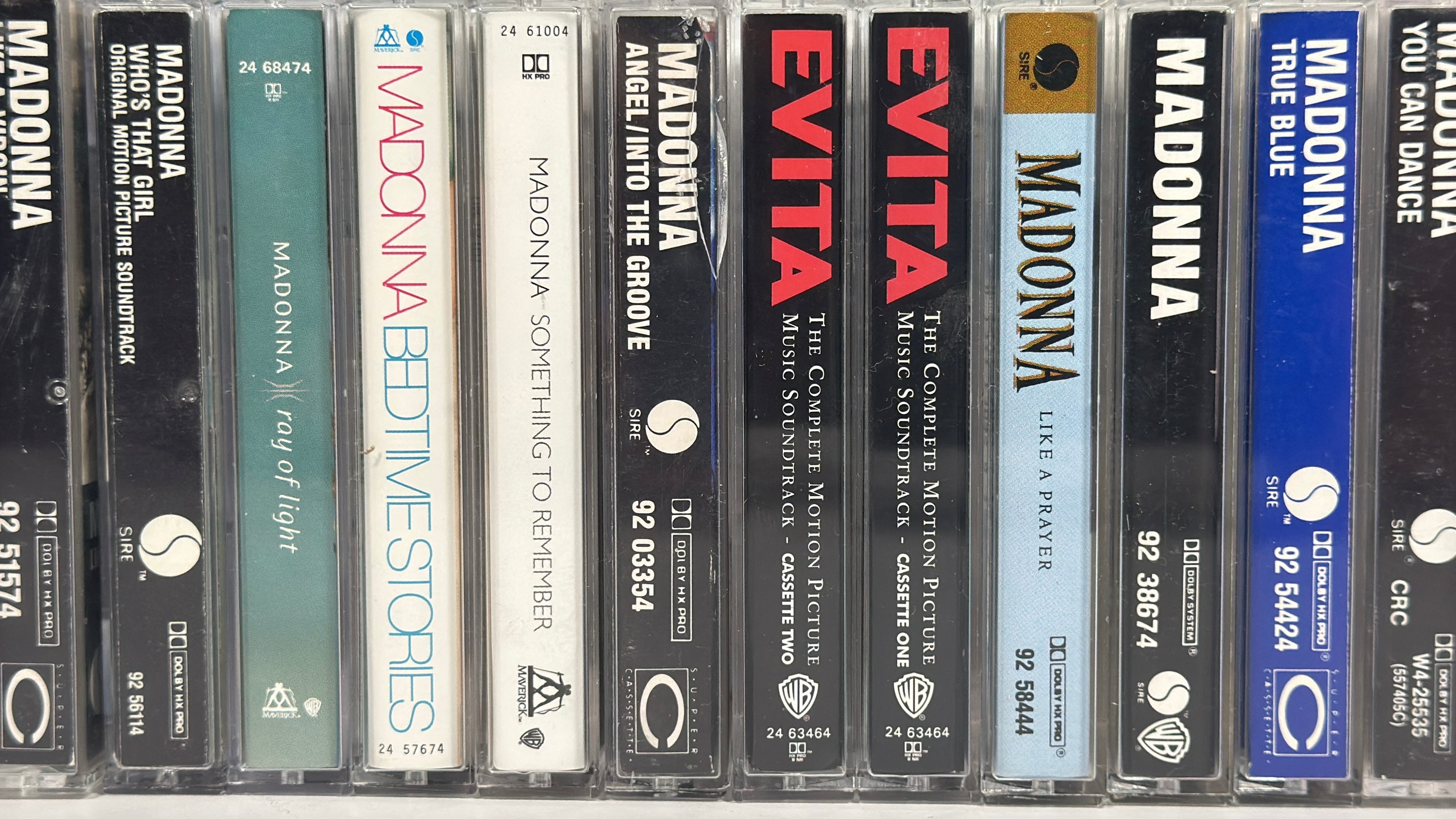 Vintage Madonna cassette tape lot featuring 12 albums from the 80s and 90s including Like a Virgin, True Blue, and Ray of Light, complete with cases.