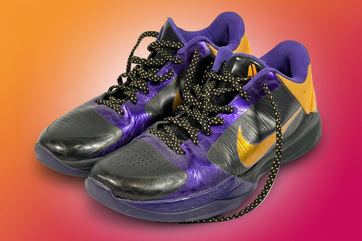 Nike Kobe 4 Lakers sneakers from 2009 in purple and gold. Classic low-top basketball shoes with Zoom cushioning, Kobe signature, and iconic Mamba design.