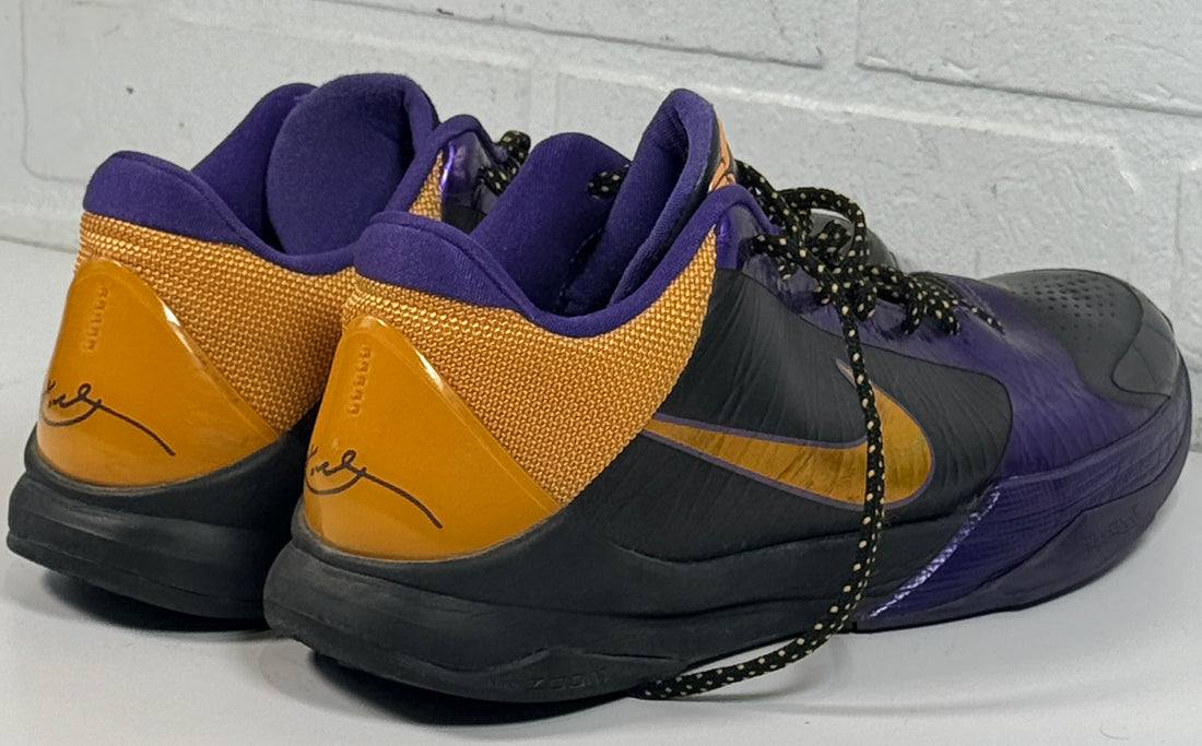 Nike Kobe 4 Lakers sneakers from 2009 in purple and gold. Classic low-top basketball shoes with Zoom cushioning, Kobe signature, and iconic Mamba design.