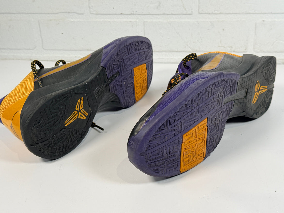 Nike Kobe 4 Lakers sneakers from 2009 in purple and gold. Classic low-top basketball shoes with Zoom cushioning, Kobe signature, and iconic Mamba design.