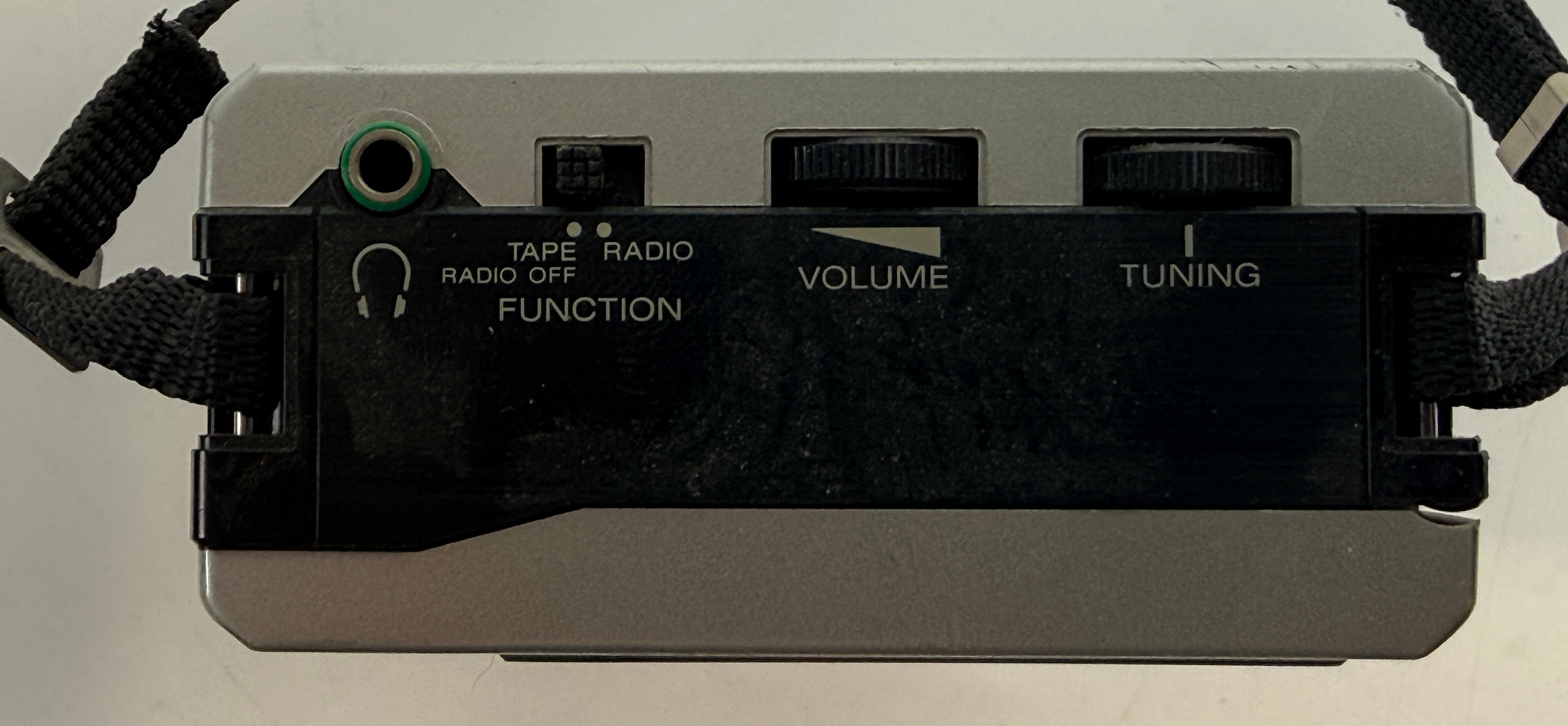 Vintage Sony Walkman WM-F12 cassette player with AM/FM radio. Classic 1980s portable audio unit with iconic design, ideal for collectors or restoration.