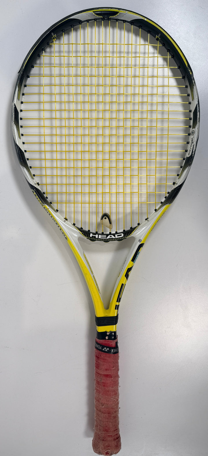HEAD MicroGel Radical tennis racquet, used player frame with mid-plus head size. Affordable performance racquet with heavy wear, ideal for practice or backup use.