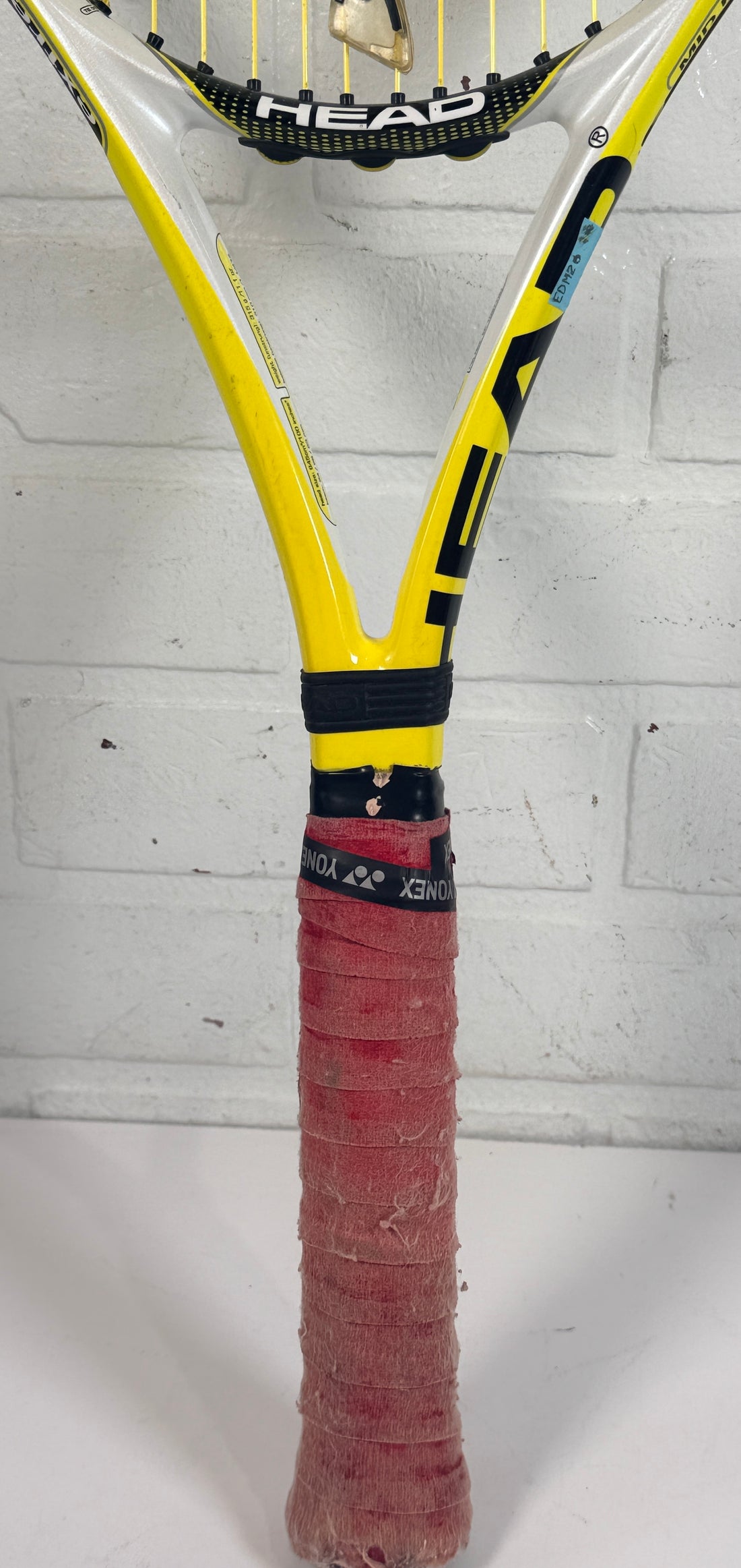 HEAD MicroGel Radical tennis racquet, used player frame with mid-plus head size. Affordable performance racquet with heavy wear, ideal for practice or backup use.