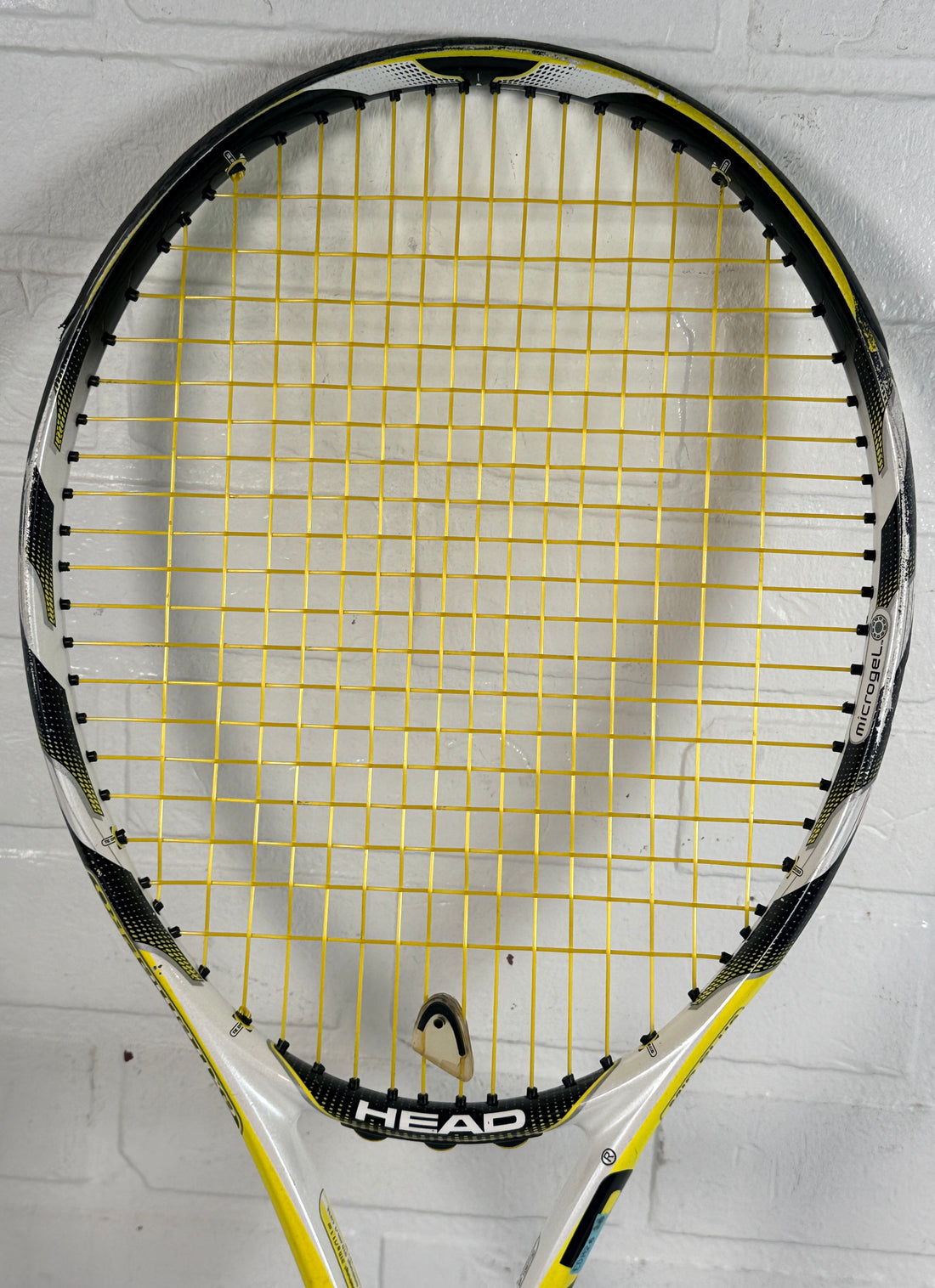 HEAD MicroGel Radical tennis racquet, used player frame with mid-plus head size. Affordable performance racquet with heavy wear, ideal for practice or backup use.