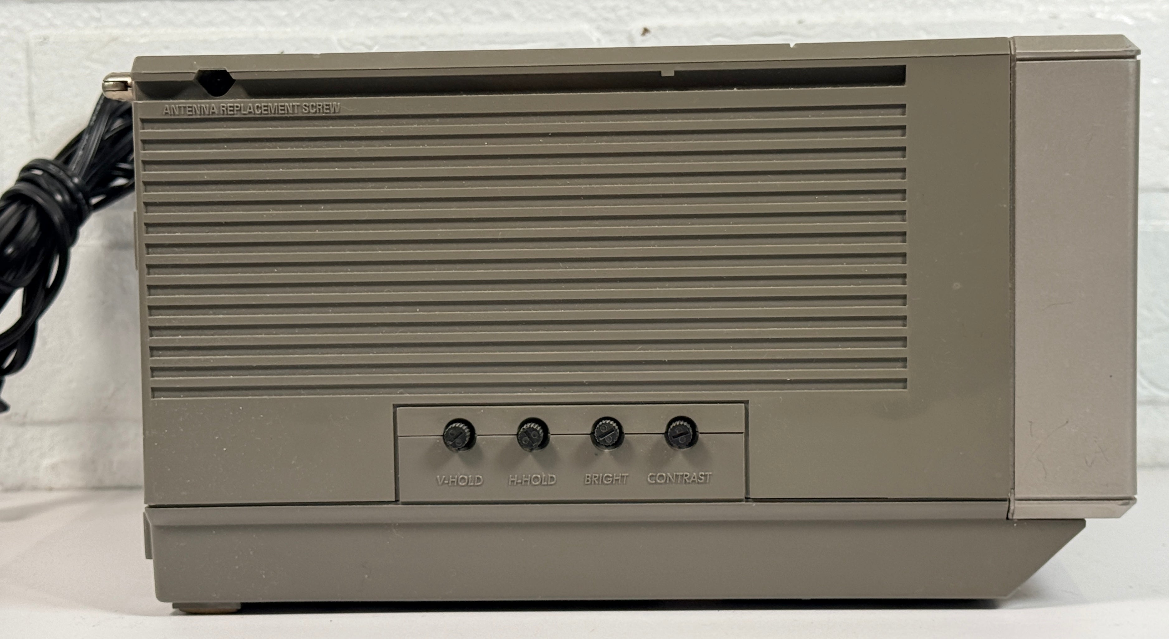Vintage GE Spacemaker portable TV from 1986, compact black &amp; white CRT with VHF/UHF tuning. Retro electronics piece perfect for display or collection.
