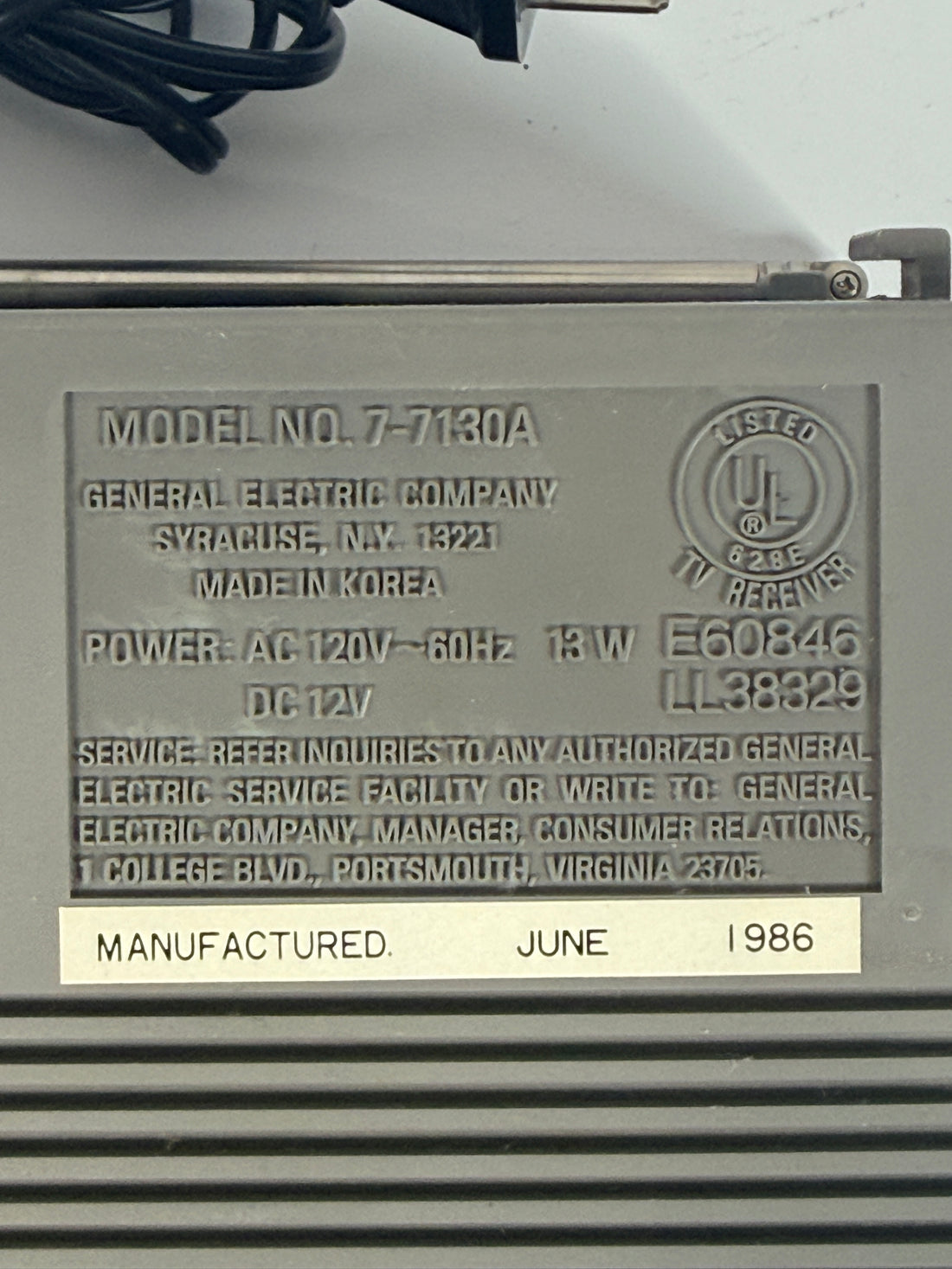 Vintage GE Spacemaker portable TV from 1986, compact black &amp; white CRT with VHF/UHF tuning. Retro electronics piece perfect for display or collection.