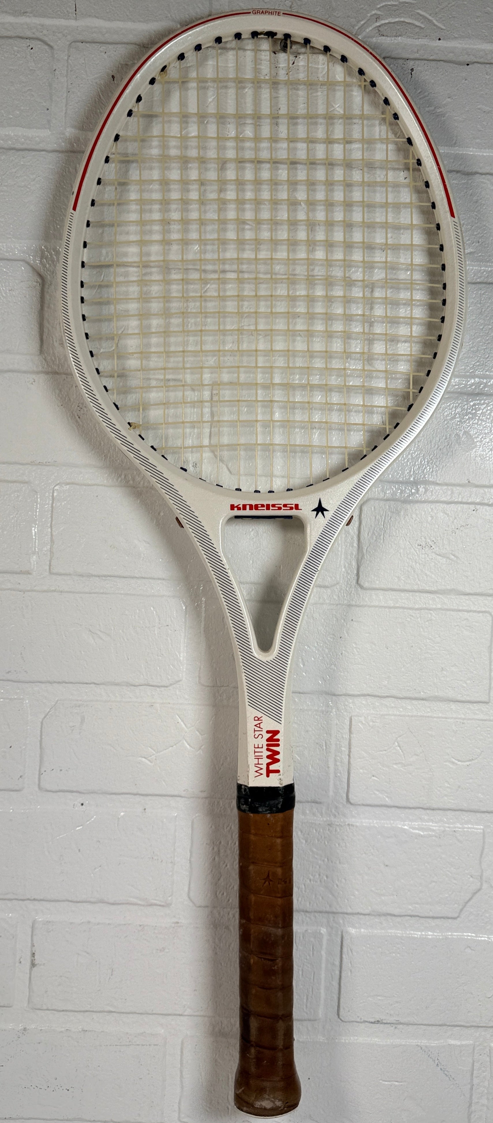 Vintage Kneissl White Star Twin tennis racquet made in Austria. Classic 1970s–80s graphite frame with leather grip. Great for display or restoration.