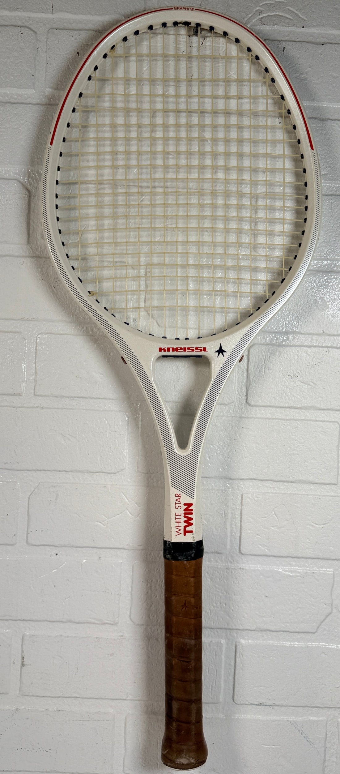 Vintage Kneissl White Star Twin tennis racquet made in Austria. Classic 1970s–80s graphite frame with leather grip. Great for display or restoration.