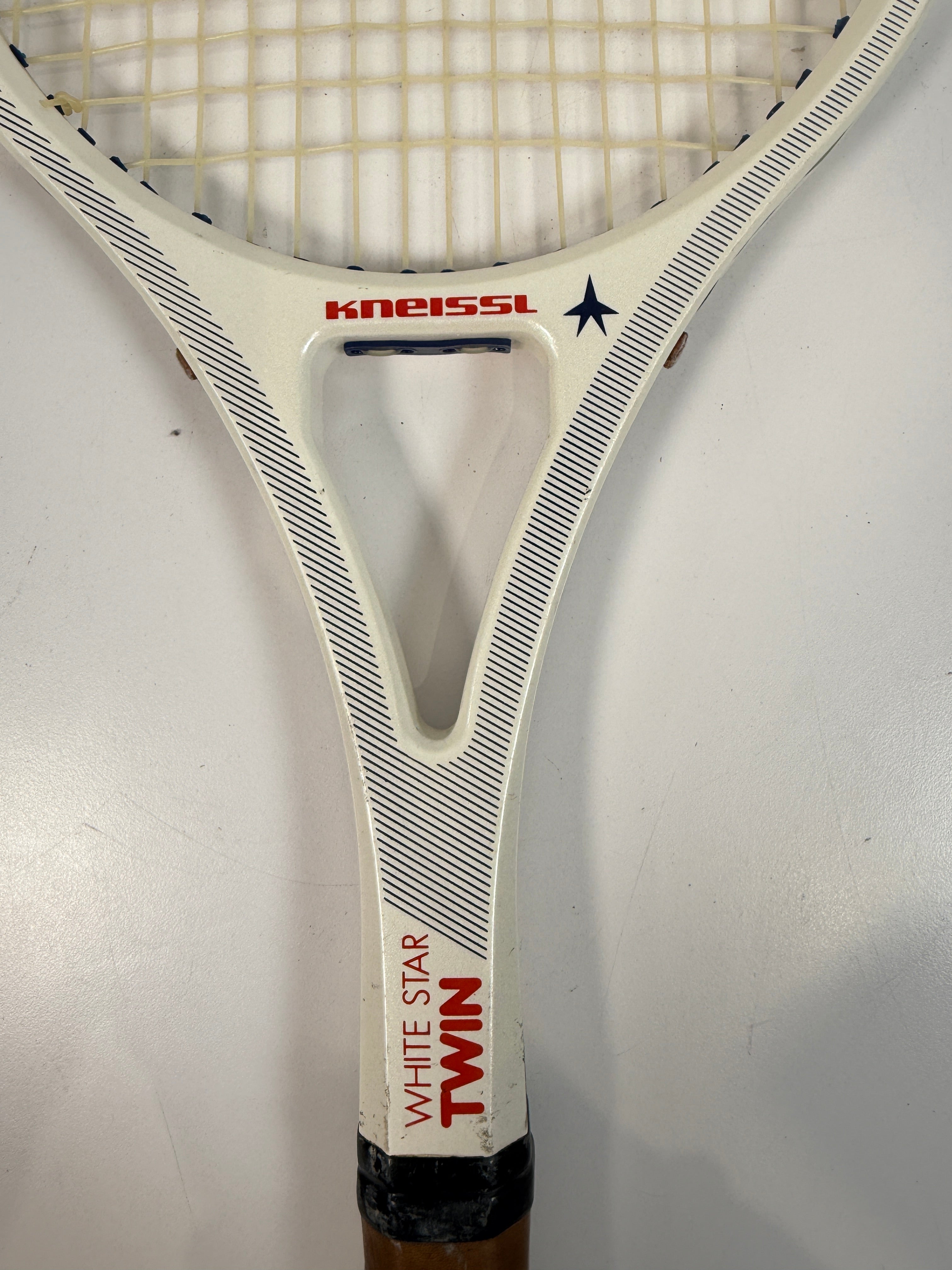 Vintage Kneissl White Star Twin tennis racquet made in Austria. Classic 1970s–80s graphite frame with leather grip. Great for display or restoration.