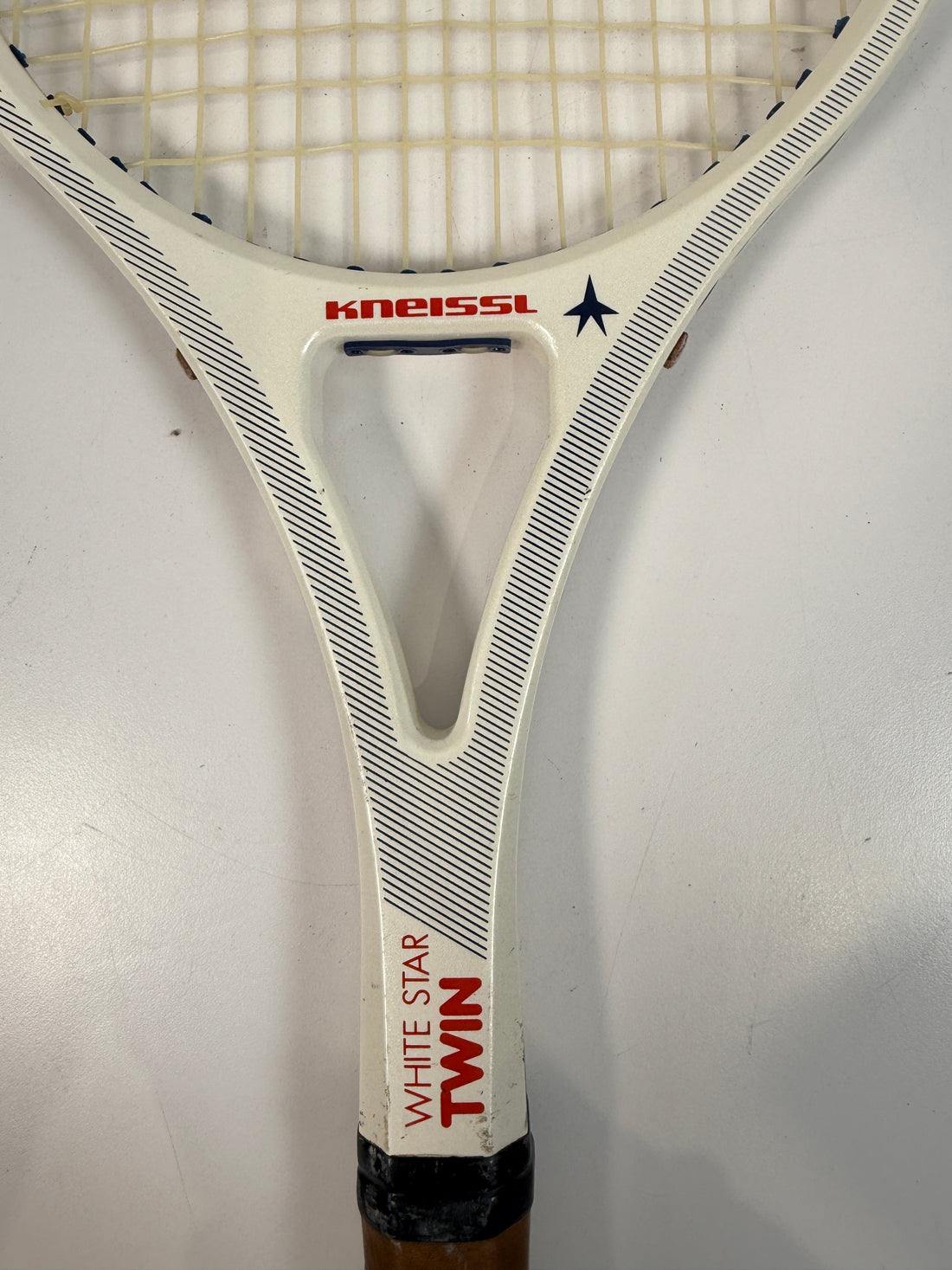 Vintage Kneissl White Star Twin tennis racquet made in Austria. Classic 1970s–80s graphite frame with leather grip. Great for display or restoration.