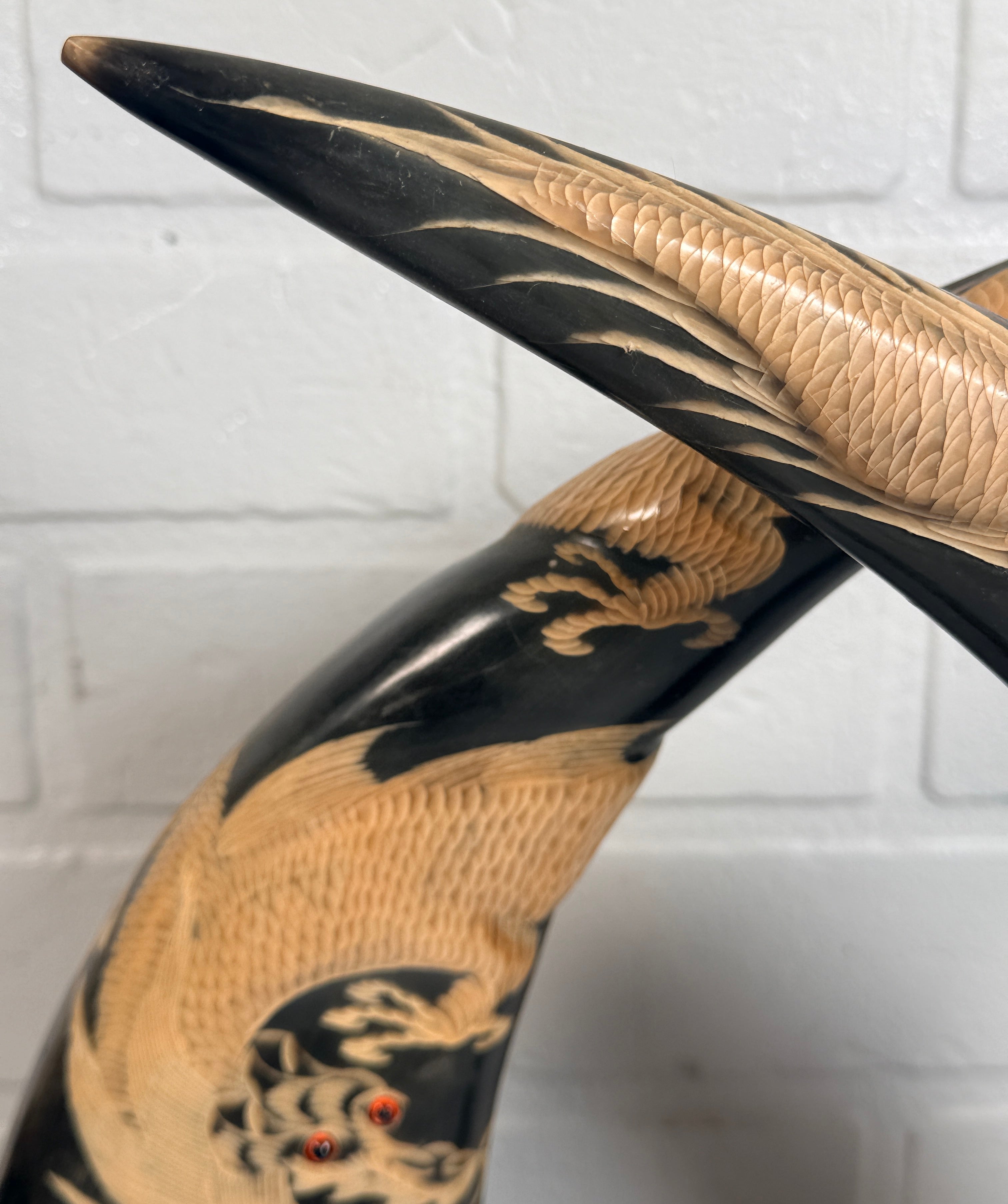 Vintage pair buffalo horn dragon phoenix statues on hardwood bases. Hand carved Asian décor sculptures with dramatic natural horn shape and collectible appeal.