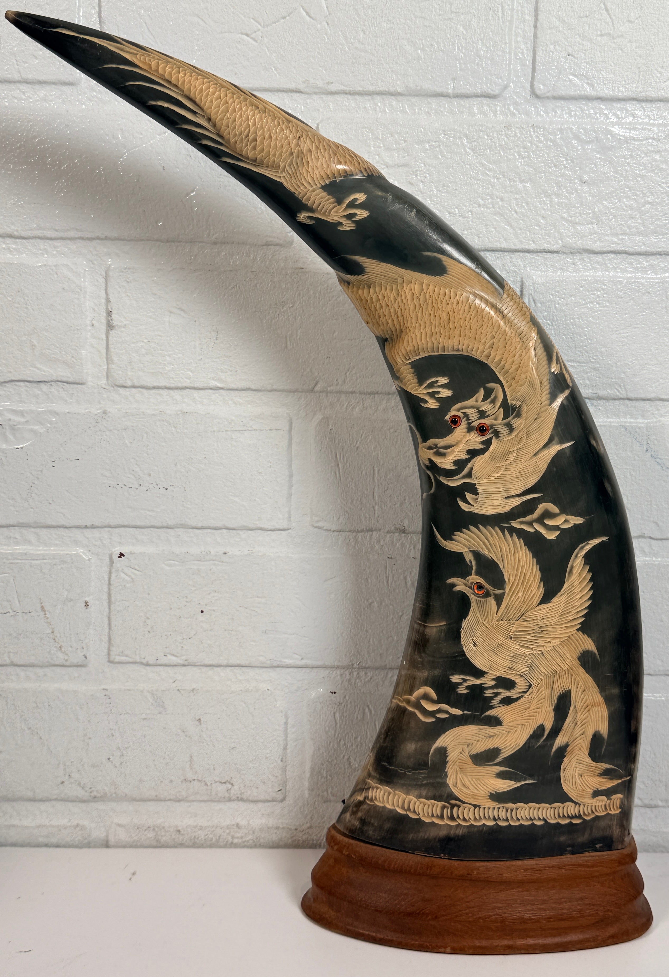 Vintage pair buffalo horn dragon phoenix statues on hardwood bases. Hand carved Asian décor sculptures with dramatic natural horn shape and collectible appeal.