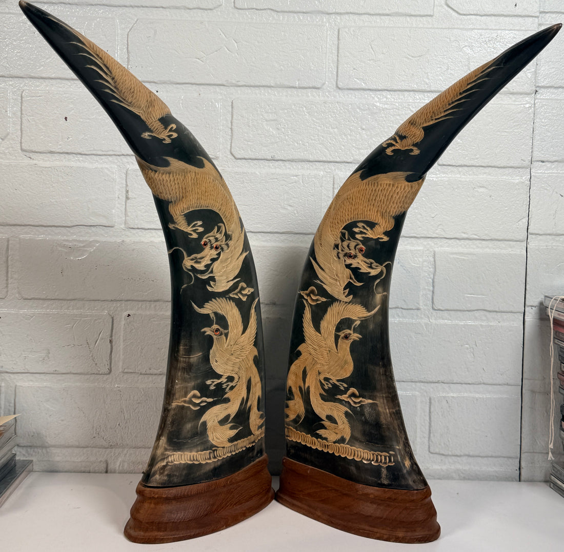 Vintage pair buffalo horn dragon phoenix statues on hardwood bases. Hand carved Asian décor sculptures with dramatic natural horn shape and collectible appeal.