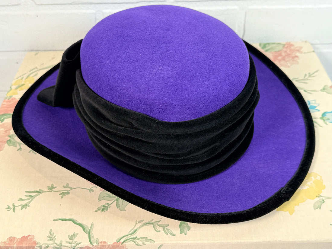 Vintage Alexon purple wool felt hat made in England with black velvet trim and bow. Elegant statement wide brim ladies formal occasion hat.