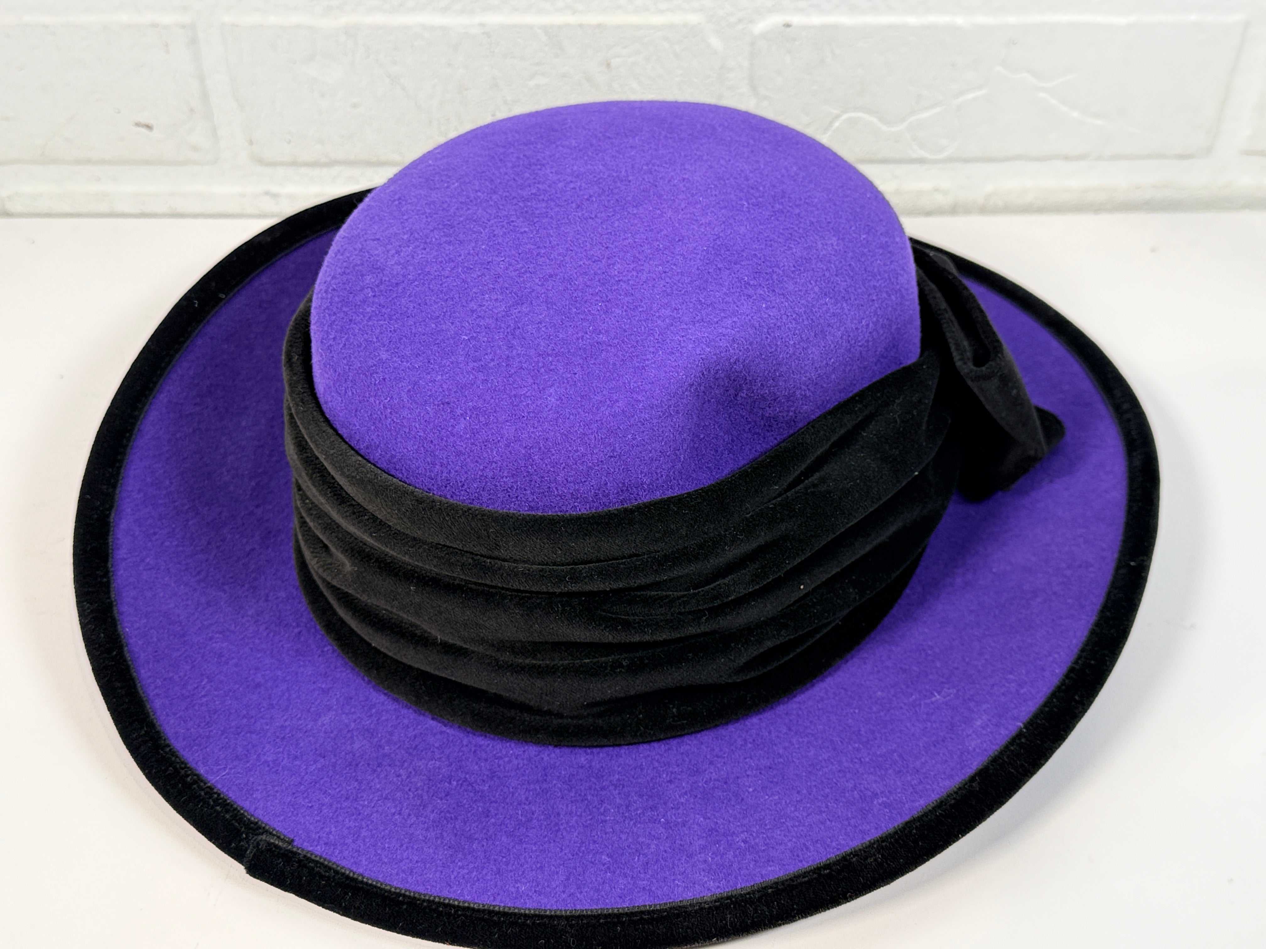 Vintage Alexon purple wool felt hat made in England with black velvet trim and bow. Elegant statement wide brim ladies formal occasion hat.
