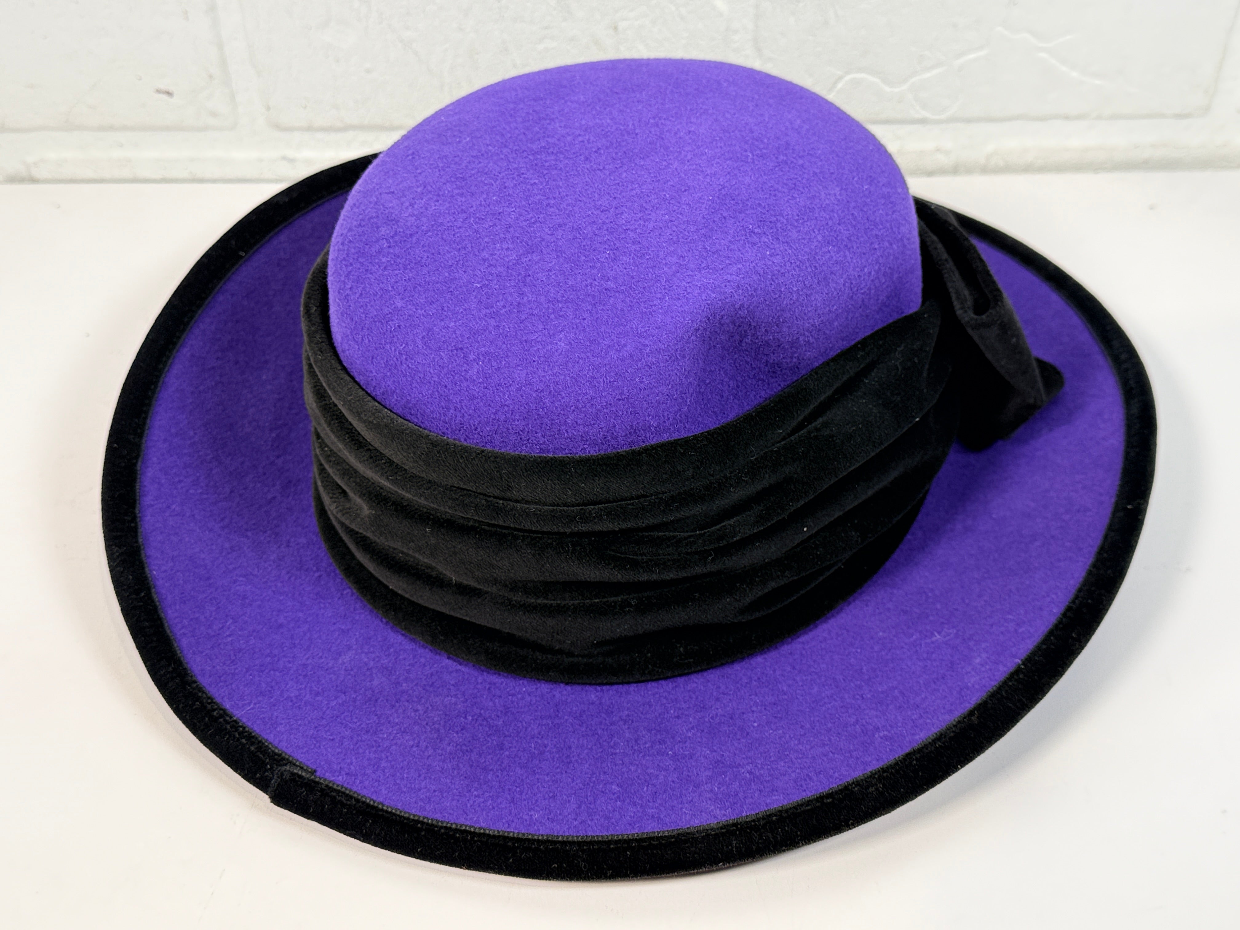 Vintage Alexon purple wool felt hat made in England with black velvet trim and bow. Elegant statement wide brim ladies formal occasion hat.