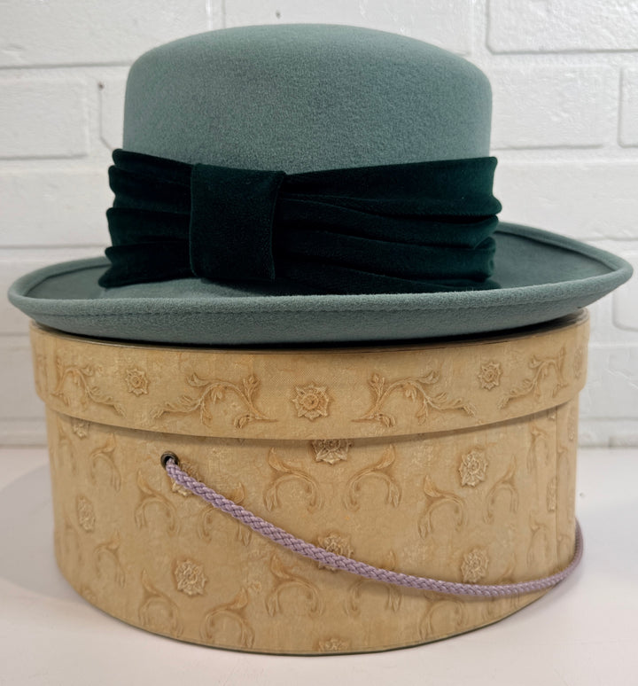 Vintage Alexon wool felt hat in mint green with black velvet trim, made in Great Britain. Includes original hat box. Elegant retro formal fashion piece.