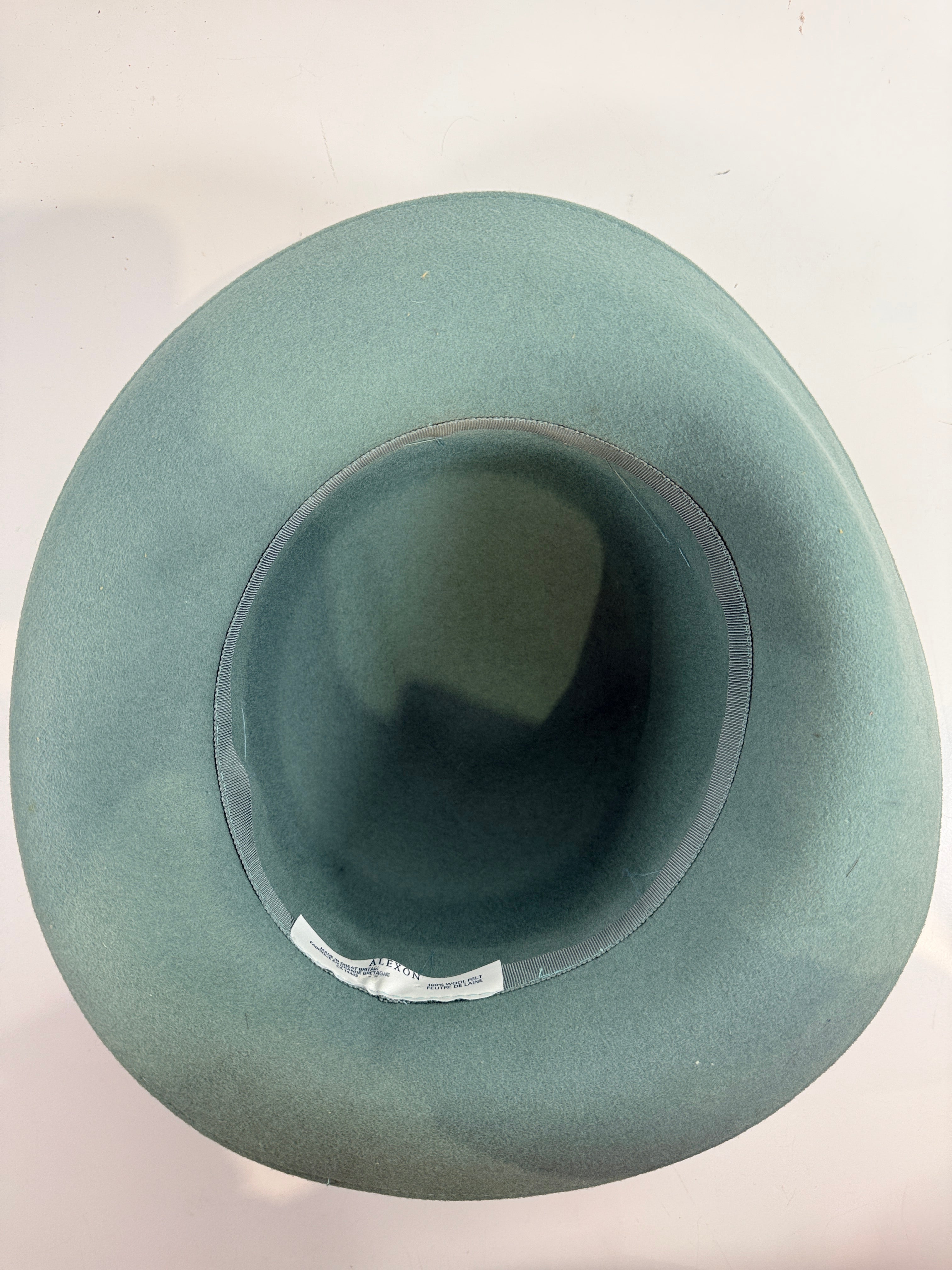 Vintage Alexon wool felt hat in mint green with black velvet trim, made in Great Britain. Includes original hat box. Elegant retro formal fashion piece.