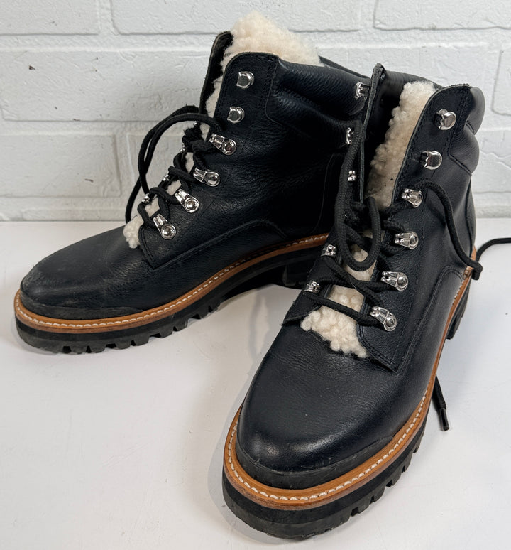 Marc Fisher shearling lined black leather hiking boots size 9M. Rugged winter lace-up ankle boots with lug soles and warm lining, pre-owned condition.