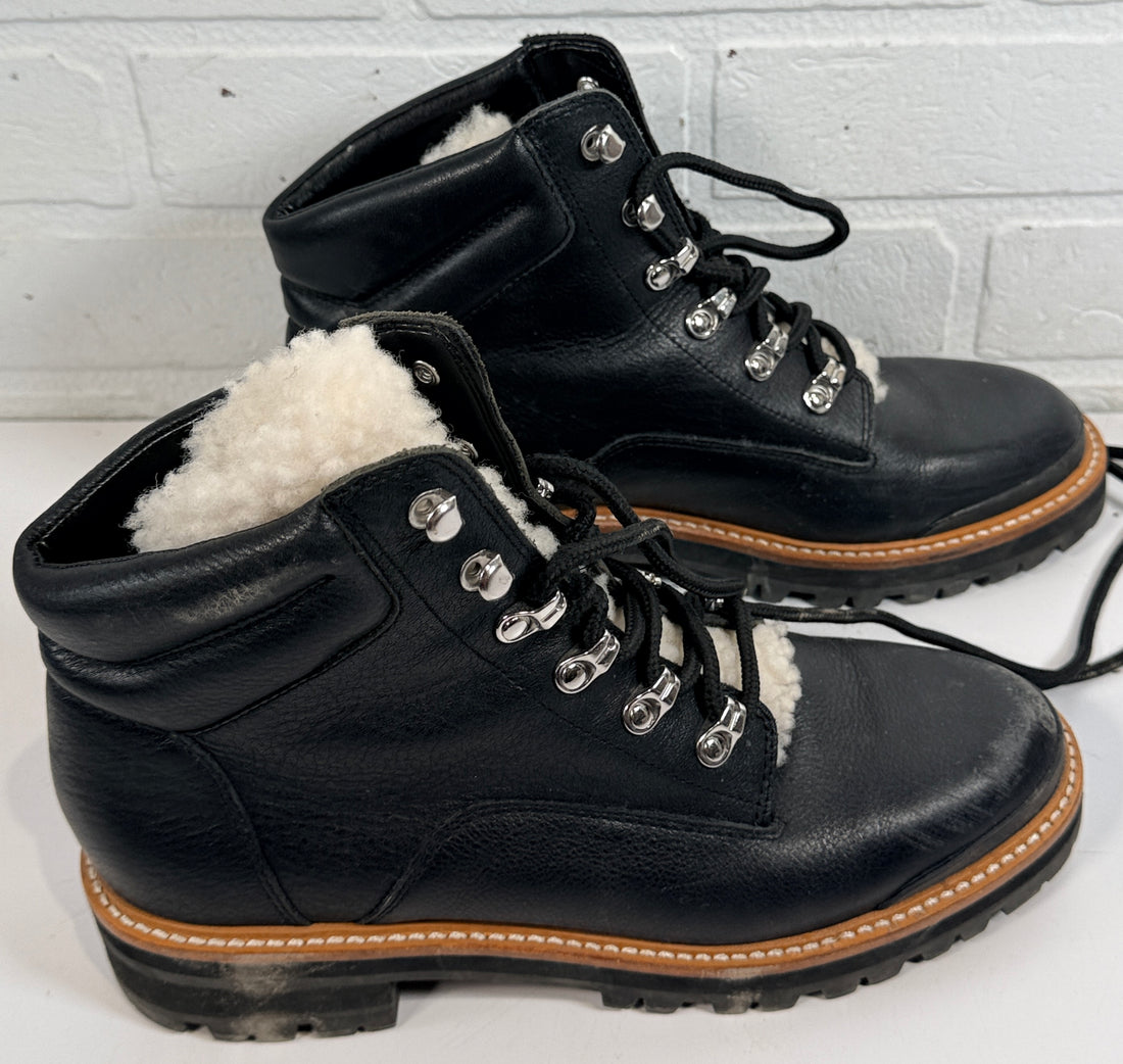 Marc Fisher shearling lined black leather hiking boots size 9M. Rugged winter lace-up ankle boots with lug soles and warm lining, pre-owned condition.
