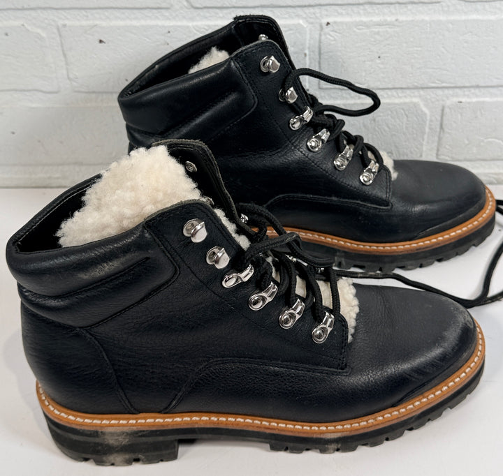 Marc Fisher shearling lined black leather hiking boots size 9M. Rugged winter lace-up ankle boots with lug soles and warm lining, pre-owned condition.