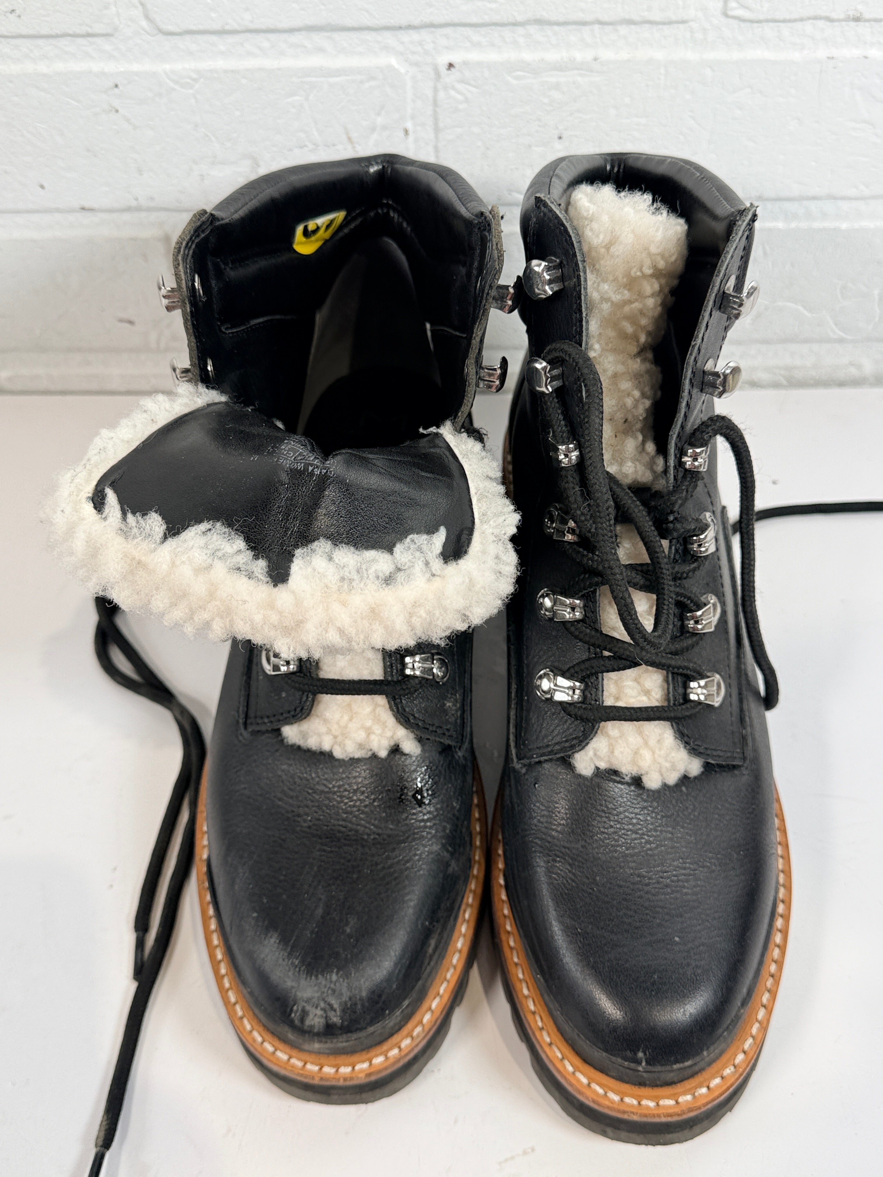Marc Fisher shearling lined black leather hiking boots size 9M. Rugged winter lace-up ankle boots with lug soles and warm lining, pre-owned condition.