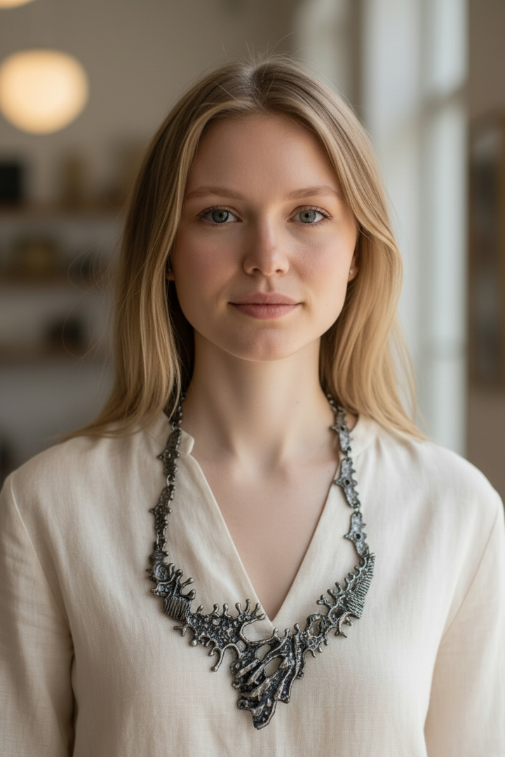 Vintage brutalist pewter necklace with sculptural modernist bib design. Unique 1970s statement jewelry in silver tone wearable art style.
