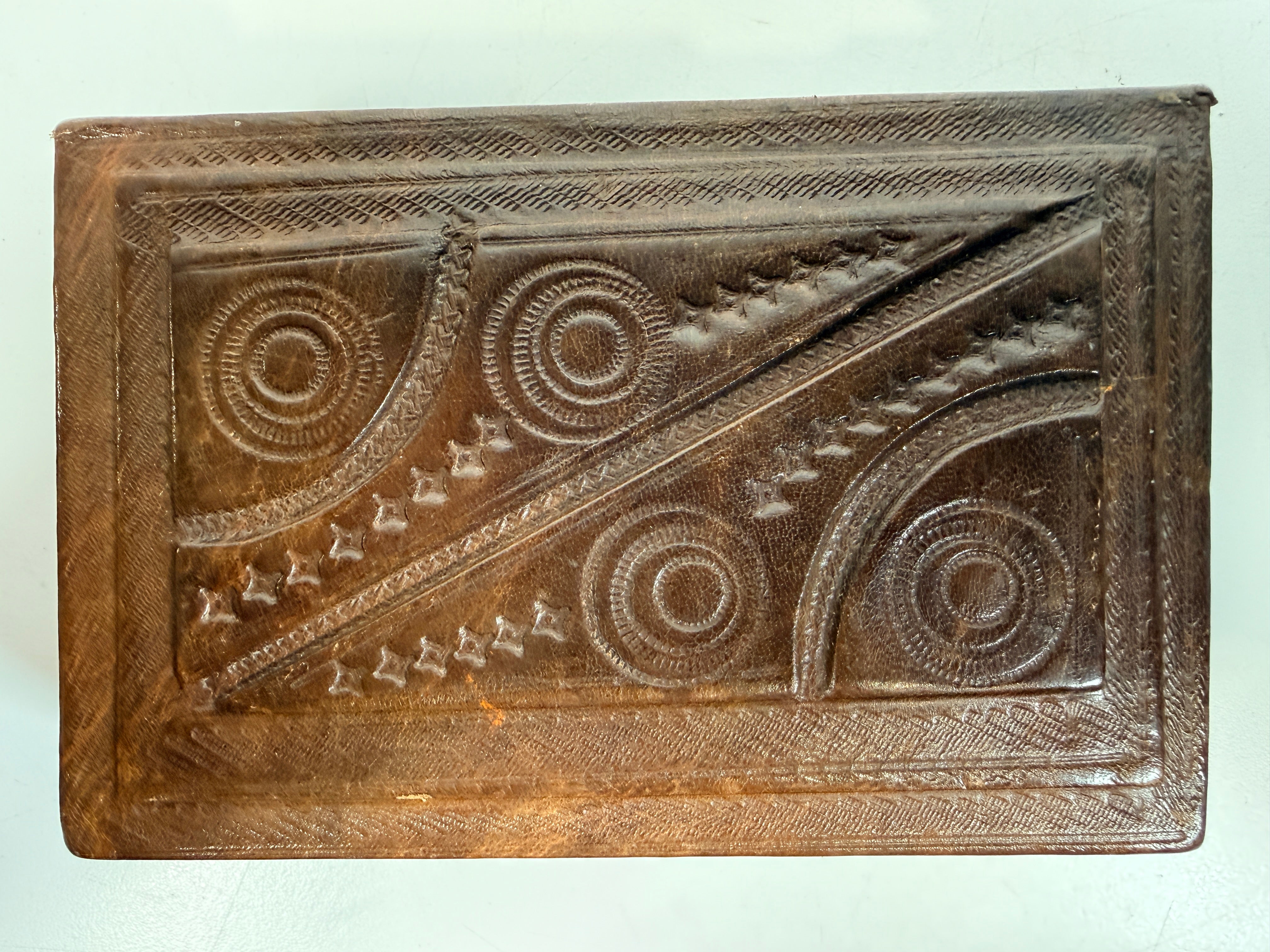 Vintage leather covered wooden box with hand tooled geometric design. Rustic keepsake jewelry storage box with removable lid and handmade charm.