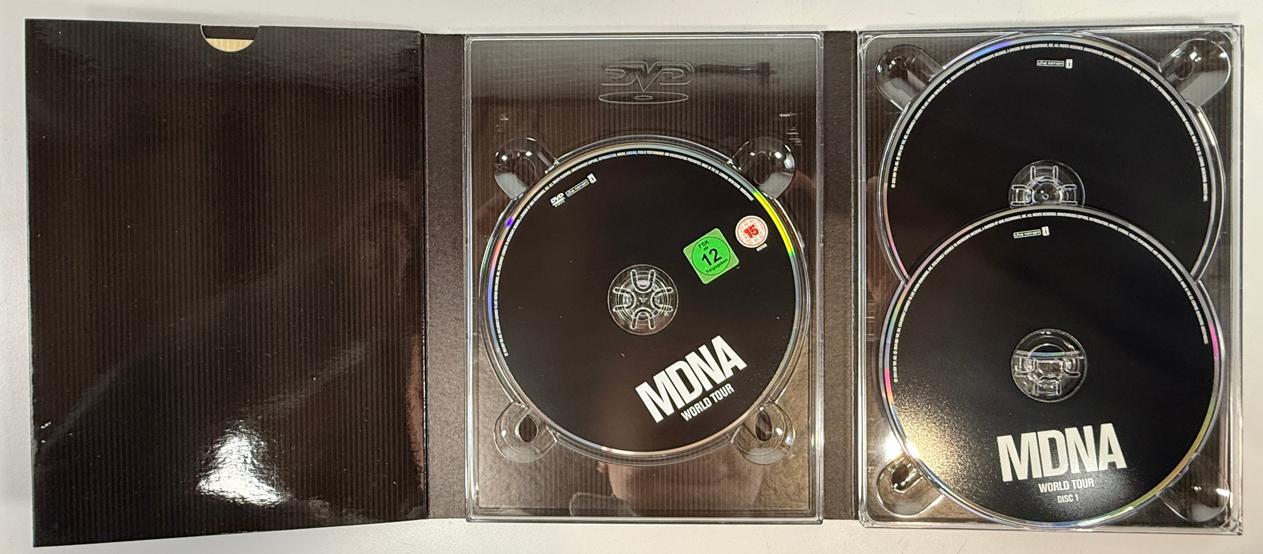 Madonna MDNA World Tour deluxe DVD + 2CD set with collector digipak packaging. Complete live concert edition with bonus content and worldwide region DVD.