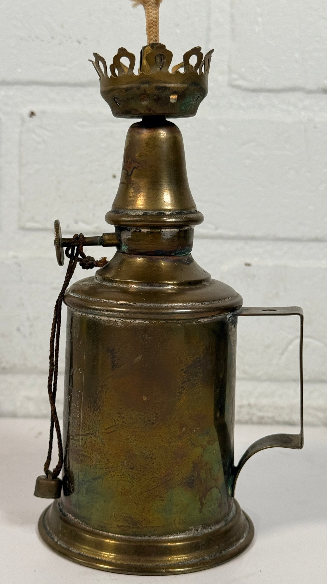 Vintage Lampe Pigeon French safety lamp with brass wall mount body, engraved markings and original patina. Collectible industrial décor display piece.