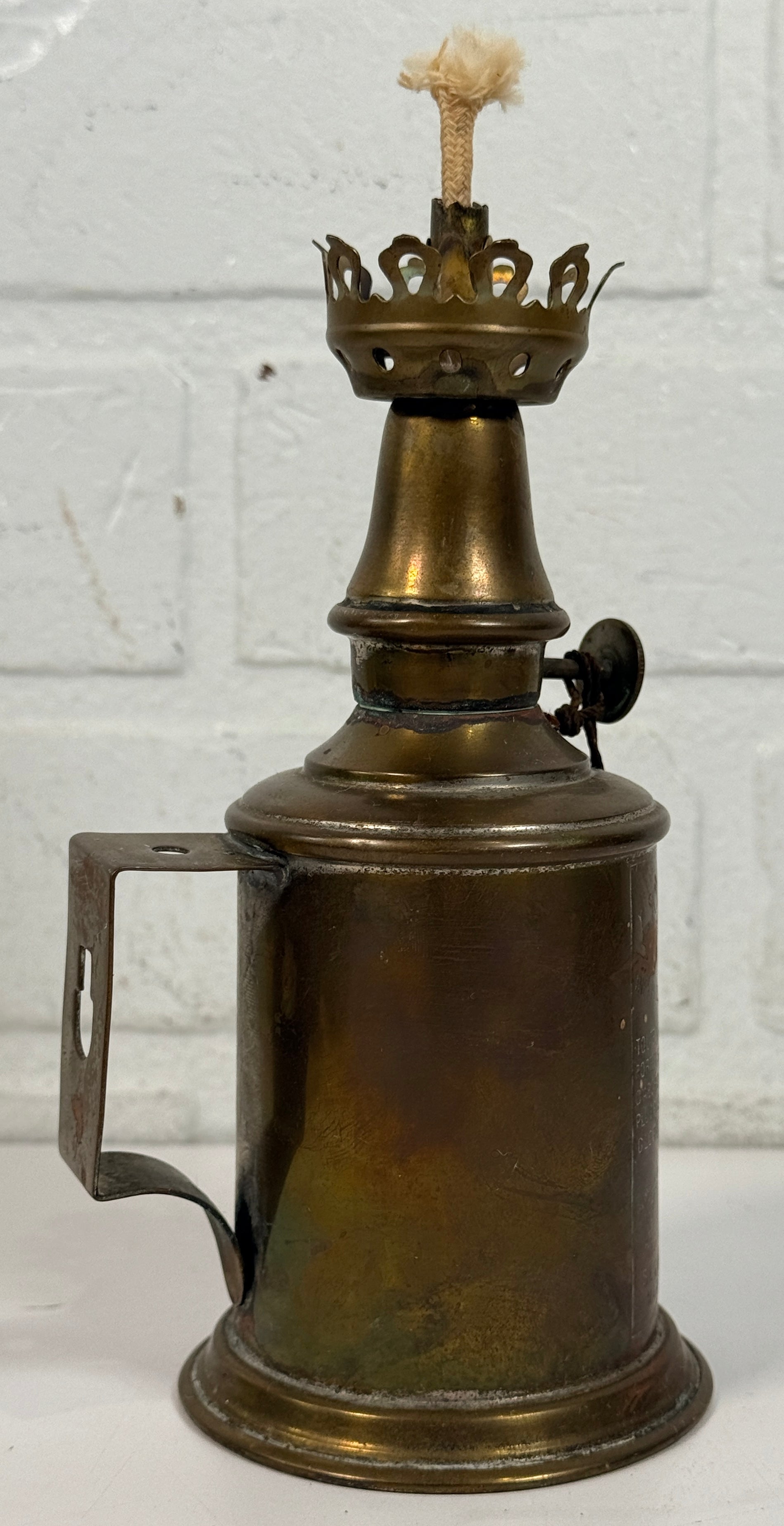 Vintage Lampe Pigeon French safety lamp with brass wall mount body, engraved markings and original patina. Collectible industrial décor display piece.