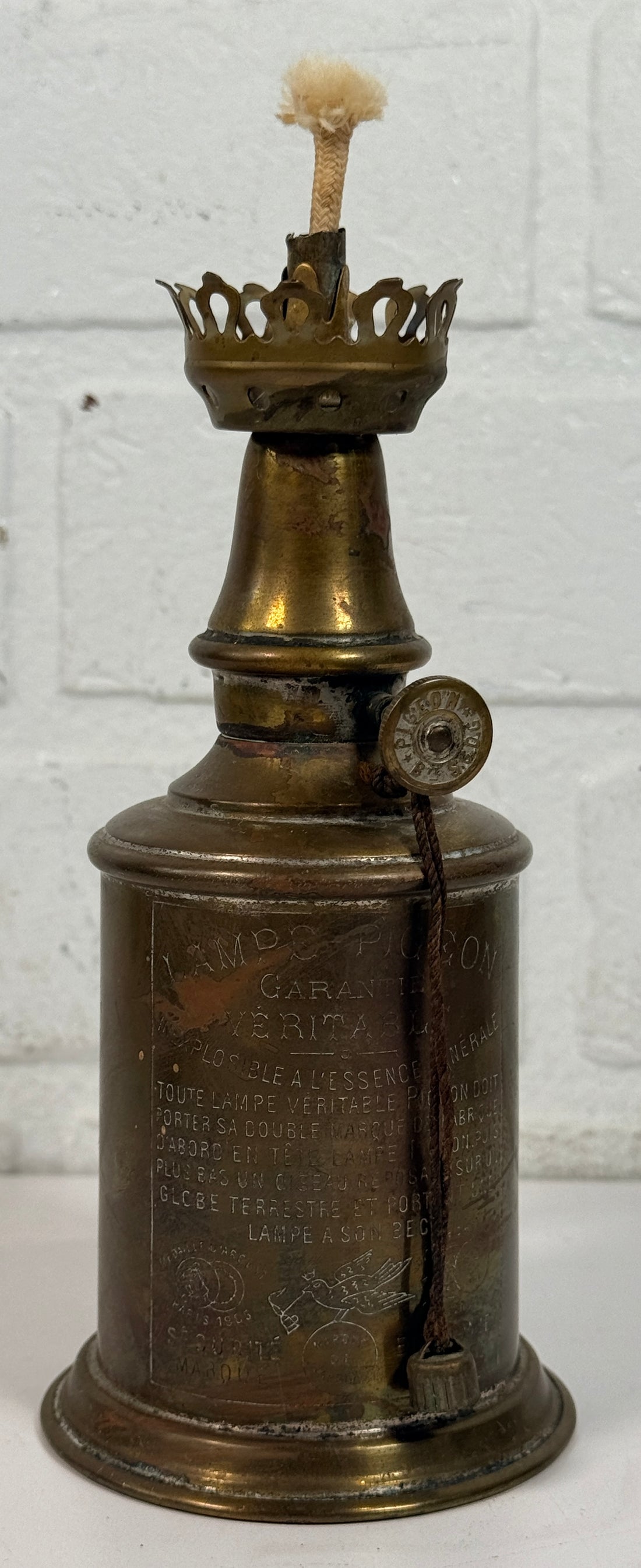 Vintage Lampe Pigeon French safety lamp with brass wall mount body, engraved markings and original patina. Collectible industrial décor display piece.