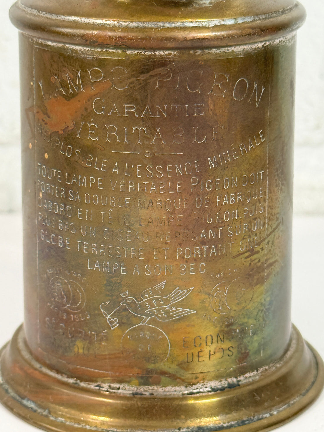 Vintage Lampe Pigeon French safety lamp with brass wall mount body, engraved markings and original patina. Collectible industrial décor display piece.