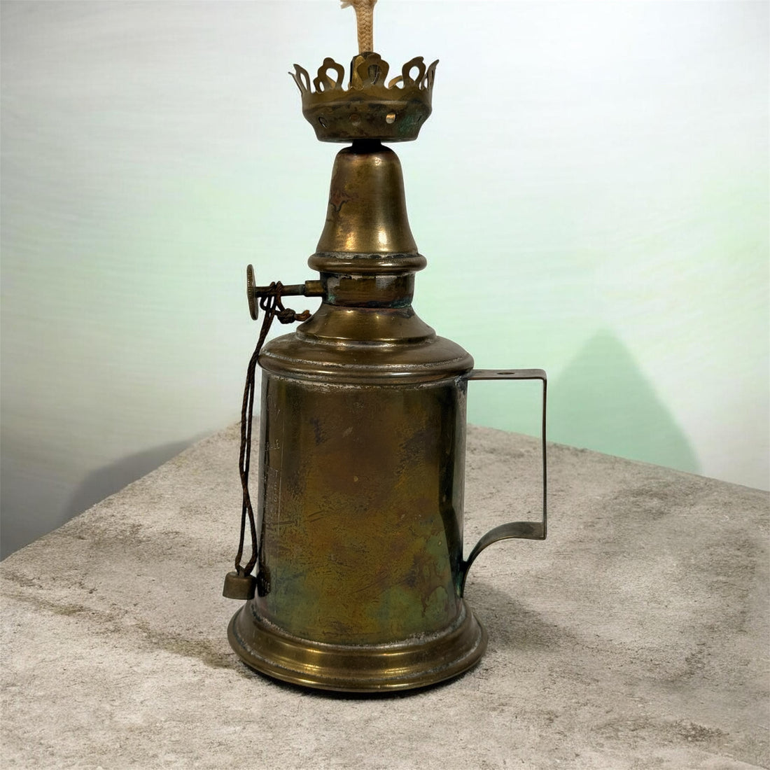 Vintage Lampe Pigeon French safety lamp with brass wall mount body, engraved markings and original patina. Collectible industrial décor display piece.