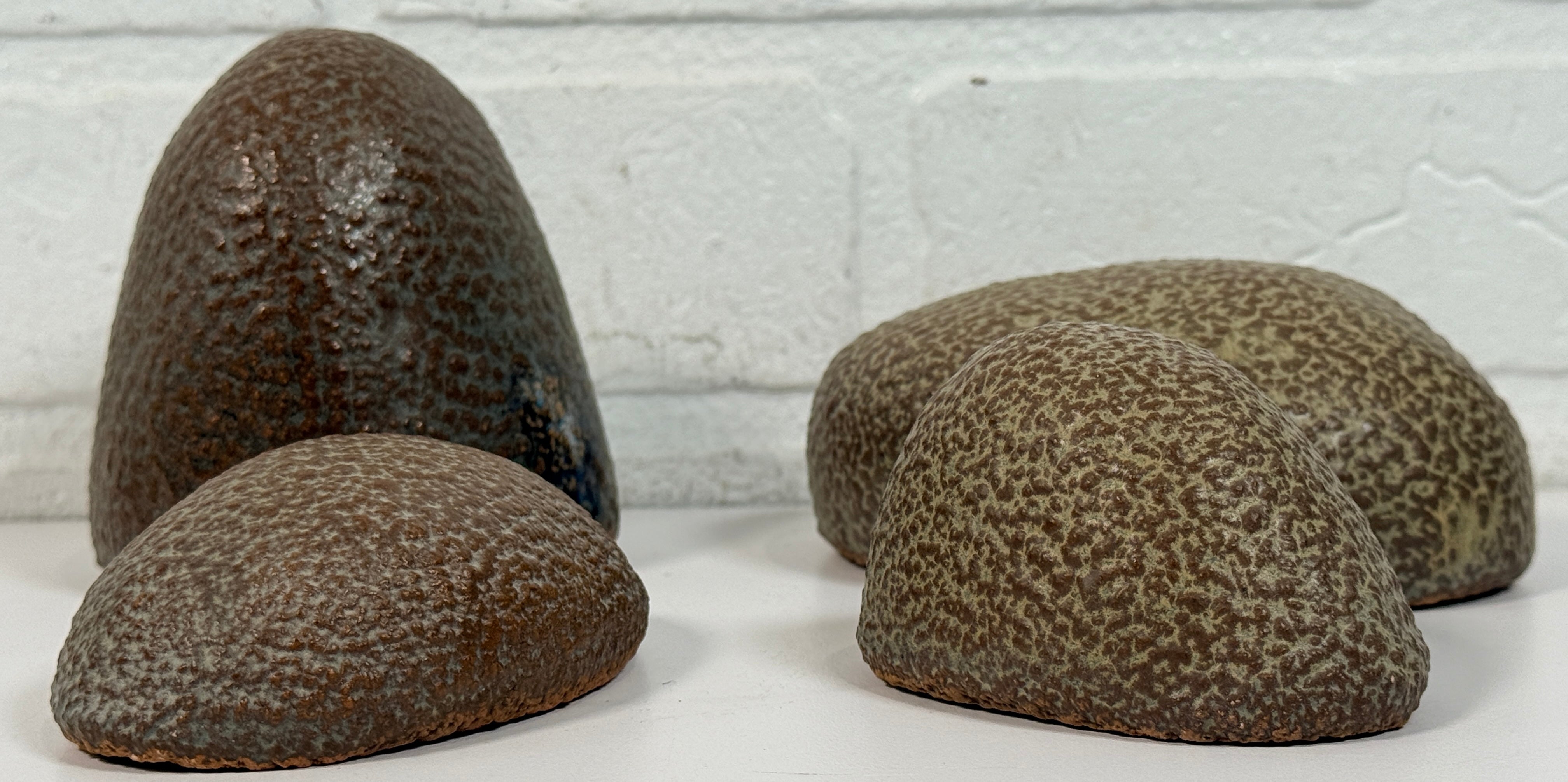 Vintage sculptural nesting pebble vessels set of 4 studio pottery ceramic organic modern brutalist decor art objects collectible display pieces.