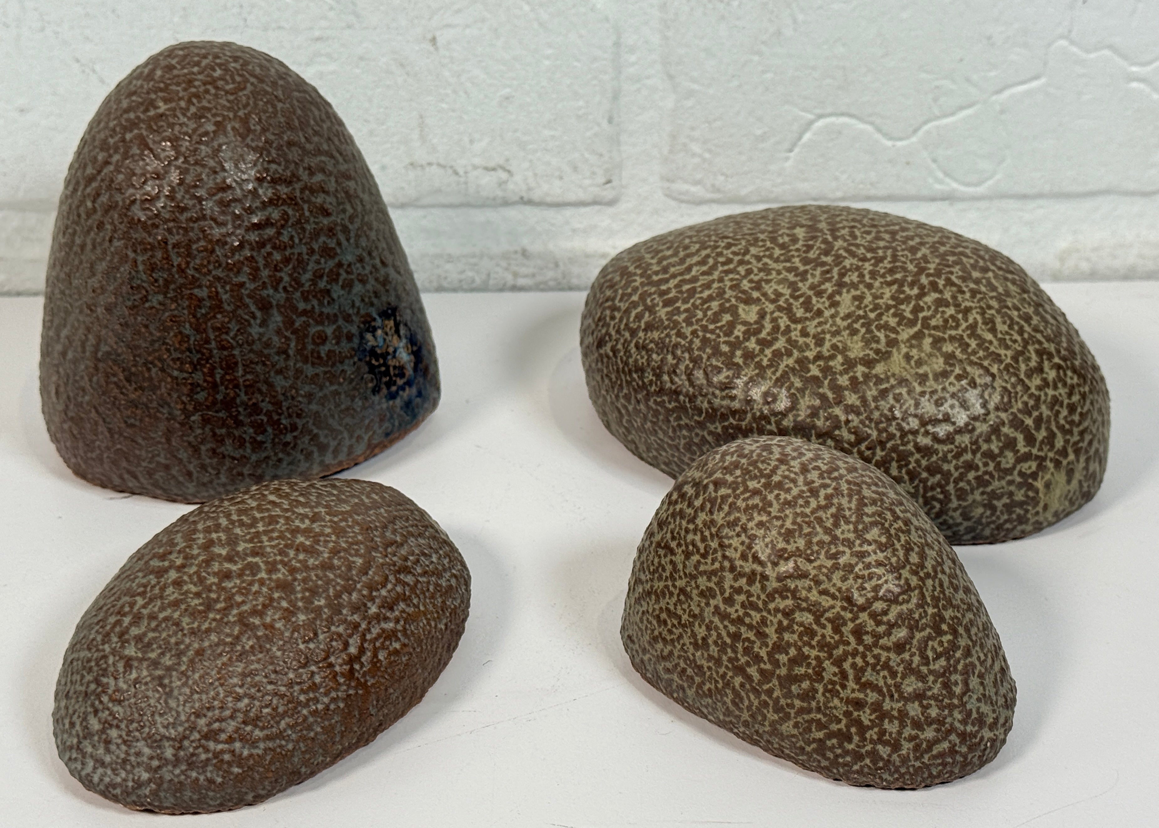 Vintage sculptural nesting pebble vessels set of 4 studio pottery ceramic organic modern brutalist decor art objects collectible display pieces.