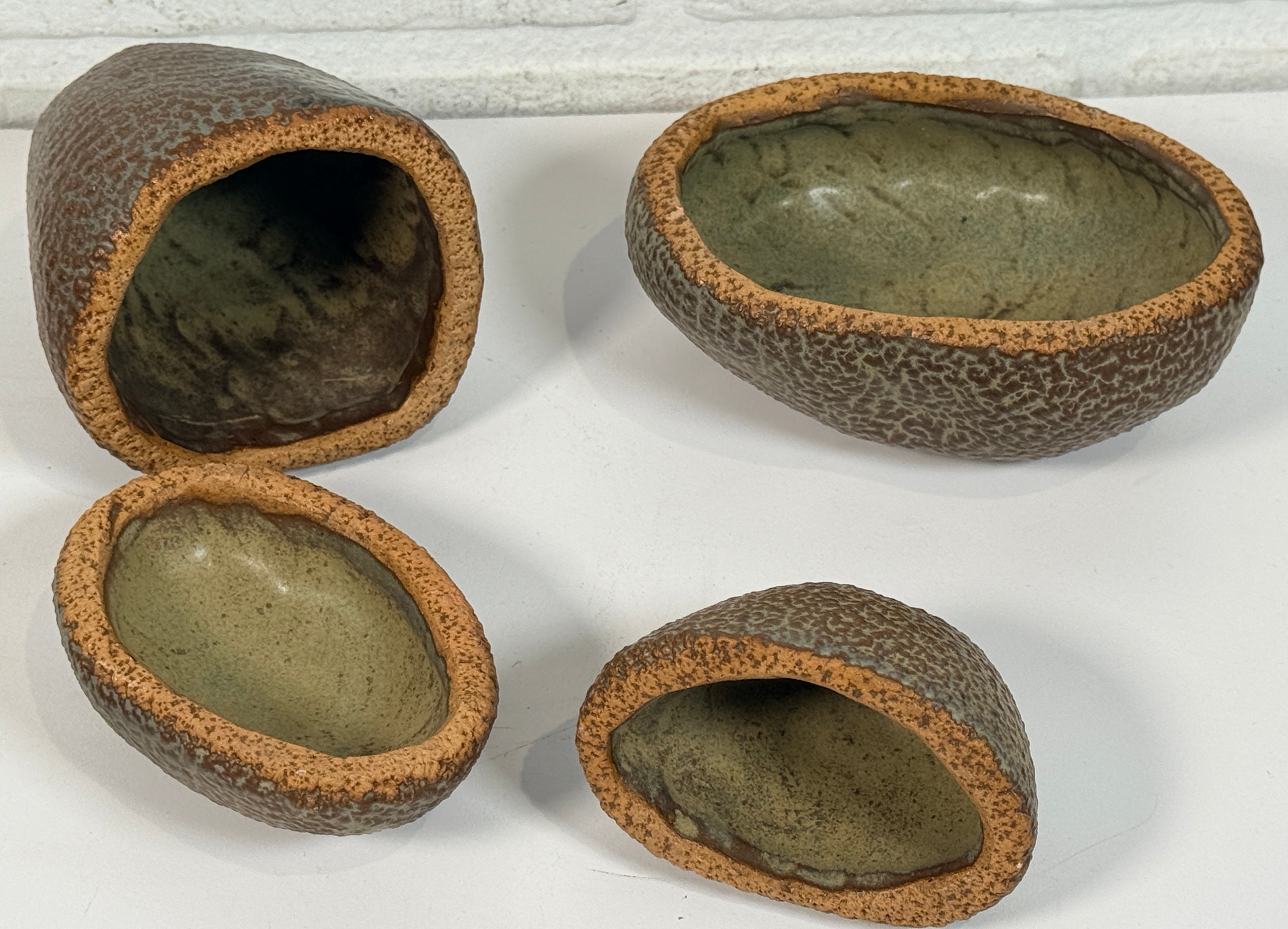 Vintage sculptural nesting pebble vessels set of 4 studio pottery ceramic organic modern brutalist decor art objects collectible display pieces.