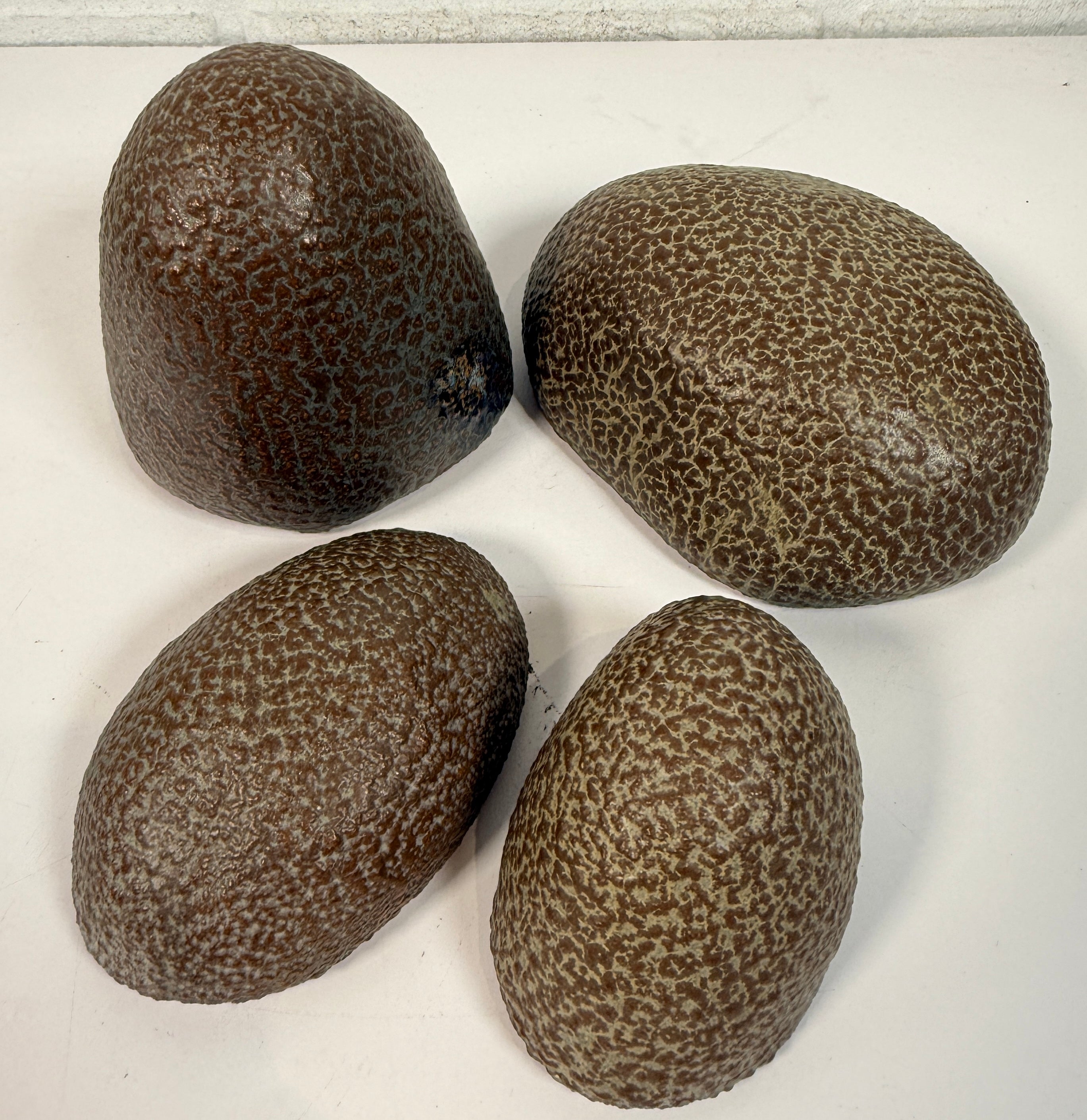 Vintage sculptural nesting pebble vessels set of 4 studio pottery ceramic organic modern brutalist decor art objects collectible display pieces.