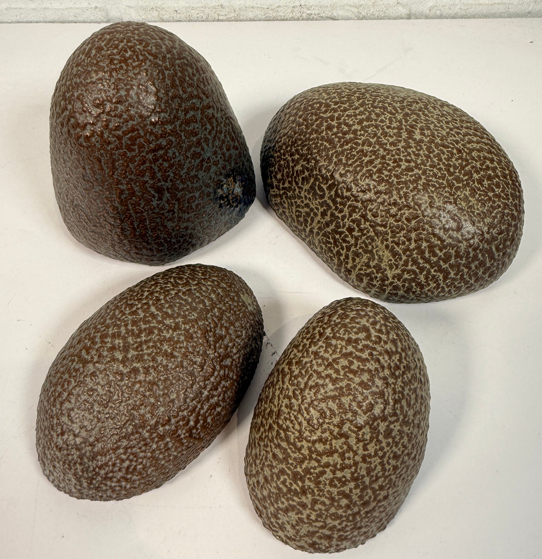 Vintage sculptural nesting pebble vessels set of 4 studio pottery ceramic organic modern brutalist decor art objects collectible display pieces.
