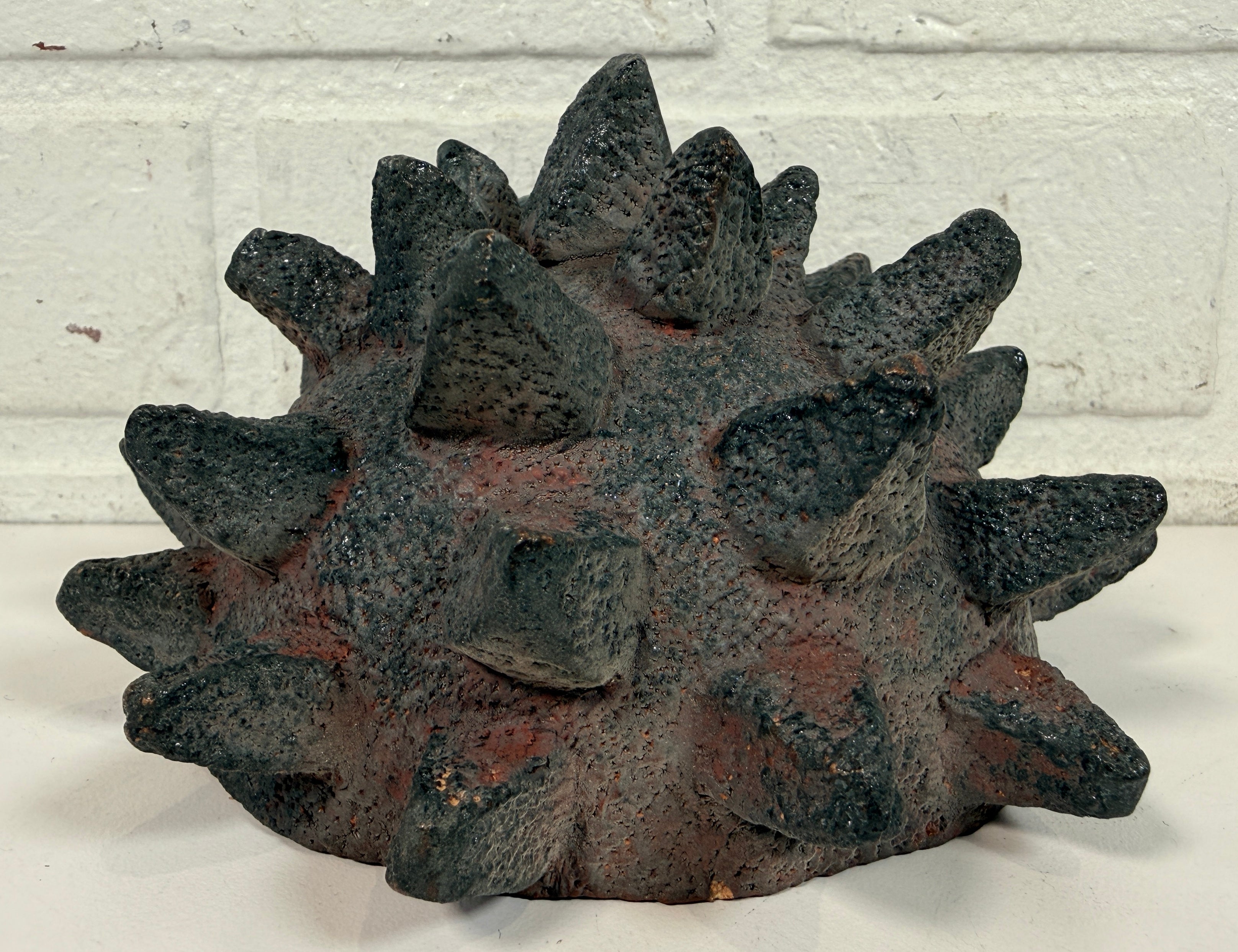 Vintage Brutalist studio pottery bowl with spiked sea urchin form, textured black exterior and glazed interior. Rare sculptural MCM centerpiece décor