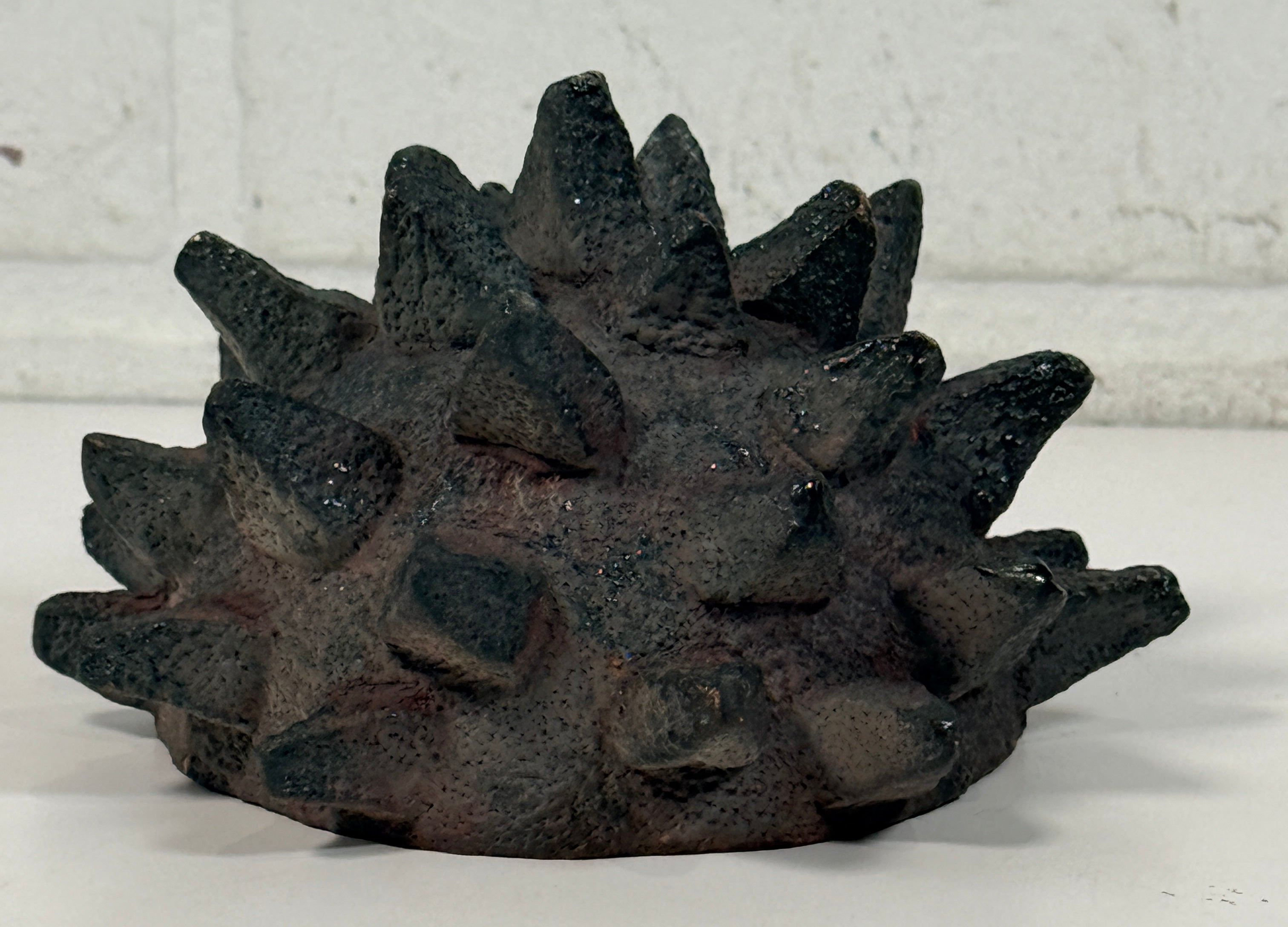 Vintage Brutalist studio pottery bowl with spiked sea urchin form, textured black exterior and glazed interior. Rare sculptural MCM centerpiece décor