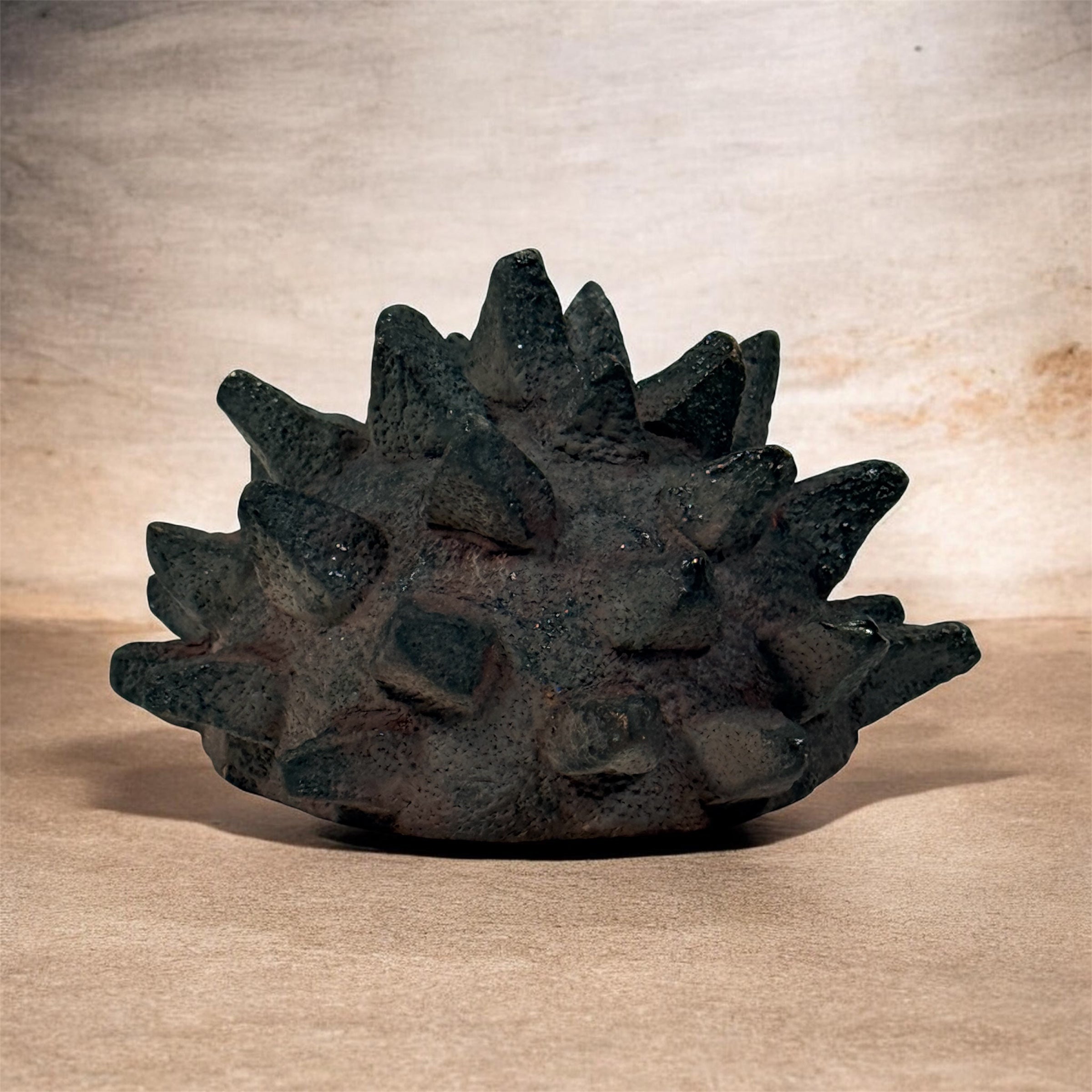 Vintage Brutalist studio pottery bowl with spiked sea urchin form, textured black exterior and glazed interior. Rare sculptural MCM centerpiece décor