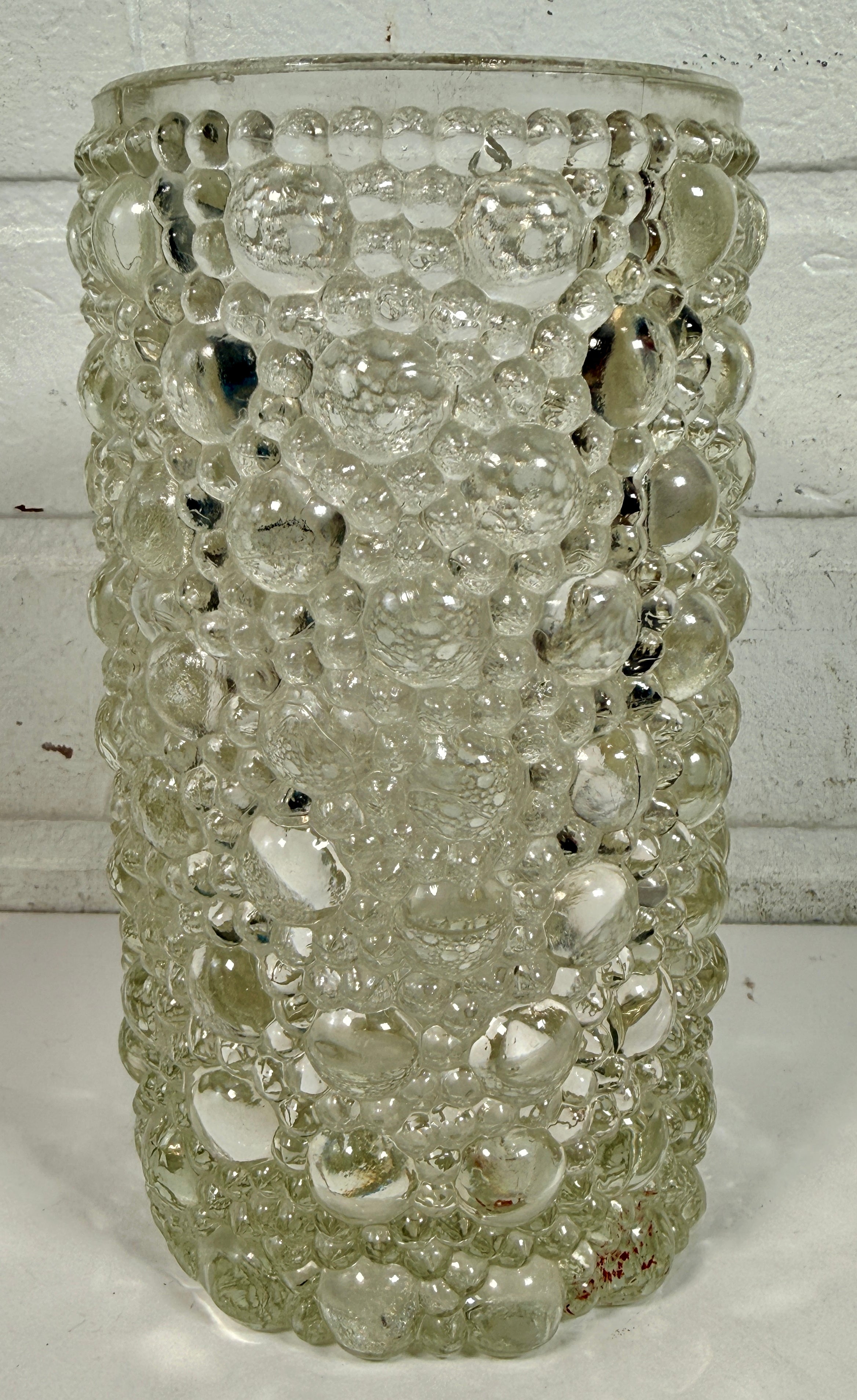 Mid-century modern clear bubble glass cylinder vase with Scandinavian style. Heavy textured art glass décor piece from the 1960s–70s.