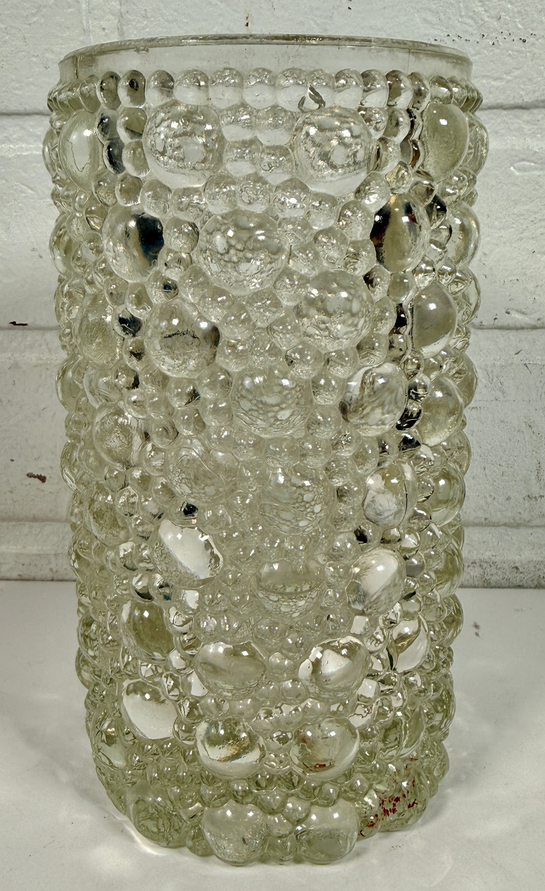 Mid-century modern clear bubble glass cylinder vase with Scandinavian style. Heavy textured art glass décor piece from the 1960s–70s.
