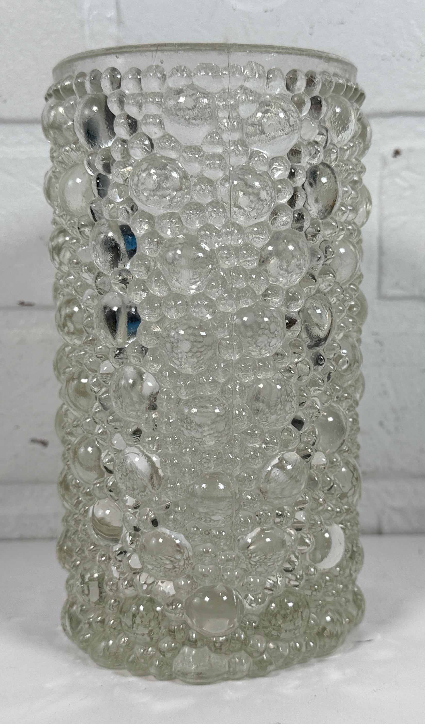 Mid-century modern clear bubble glass cylinder vase with Scandinavian style. Heavy textured art glass décor piece from the 1960s–70s.