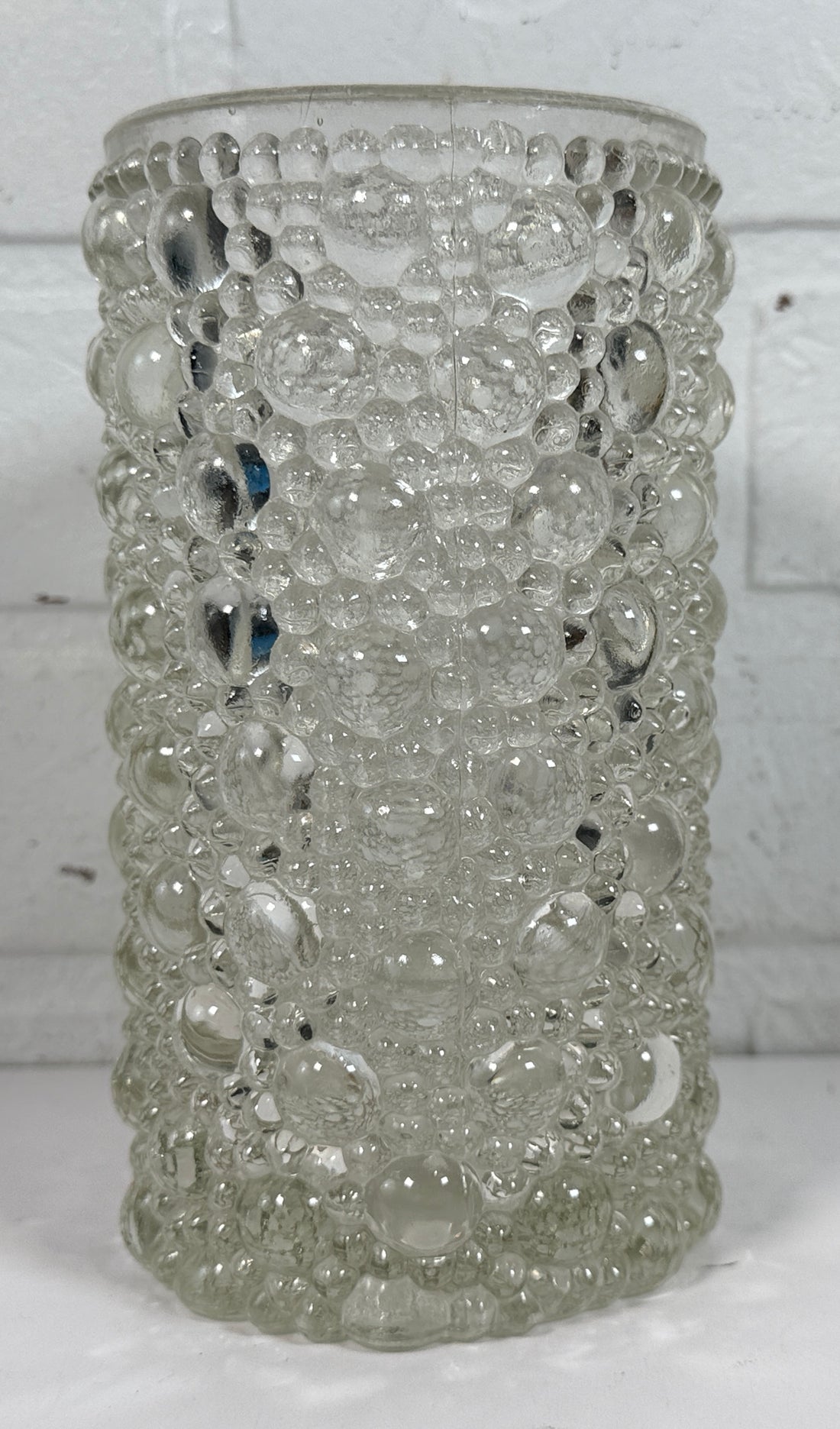 Mid-century modern clear bubble glass cylinder vase with Scandinavian style. Heavy textured art glass décor piece from the 1960s–70s.