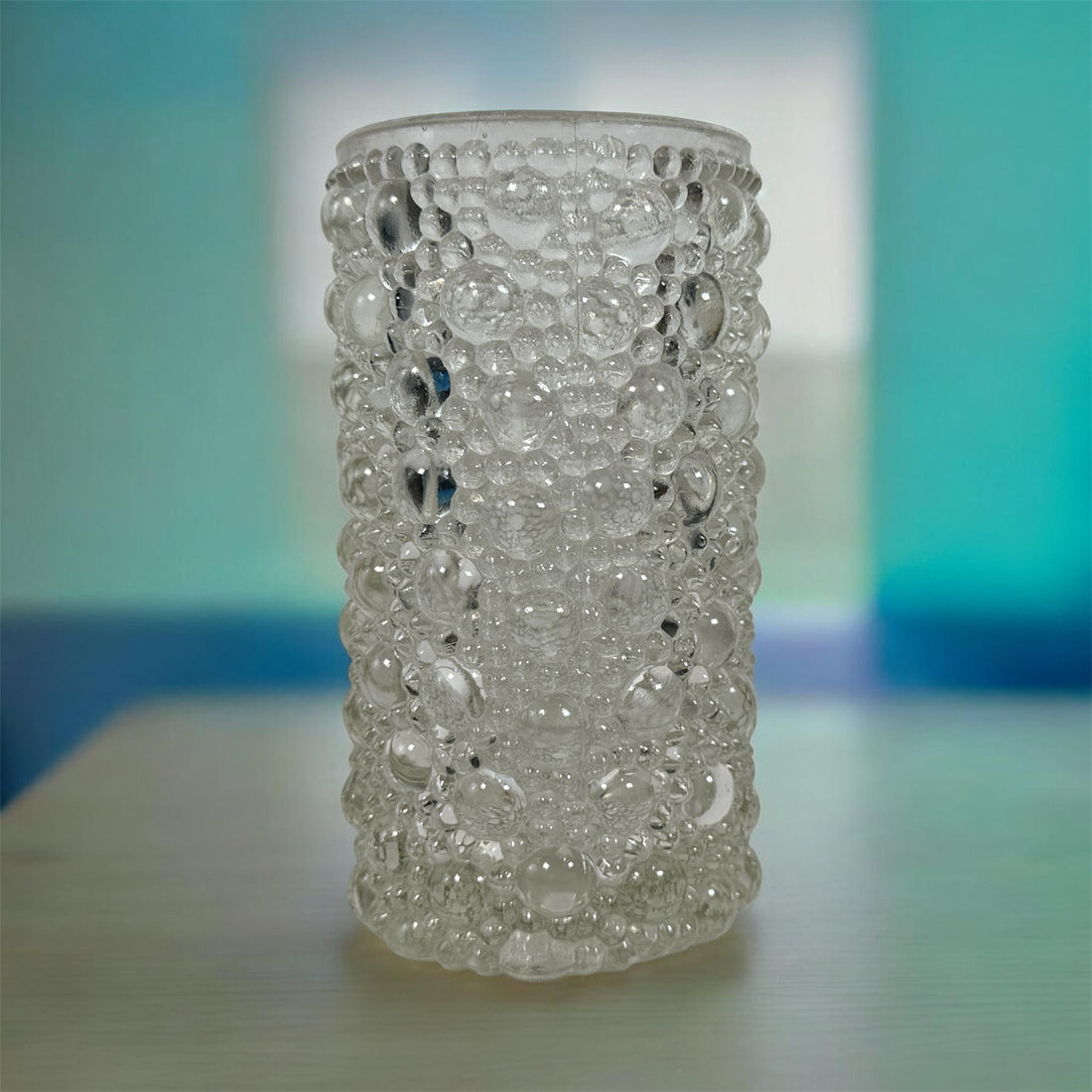 Mid-century modern clear bubble glass cylinder vase with Scandinavian style. Heavy textured art glass décor piece from the 1960s–70s.