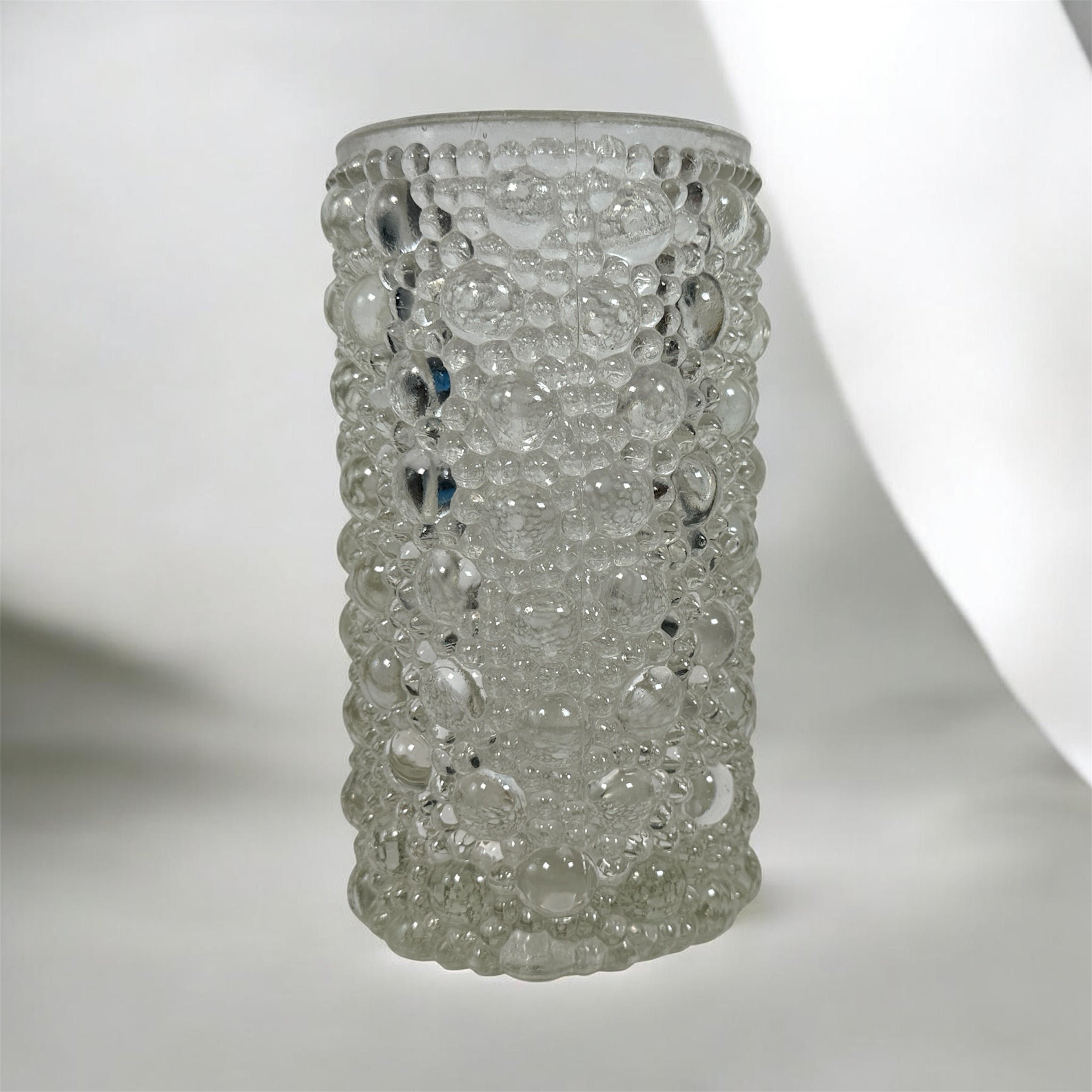 Mid-century modern clear bubble glass cylinder vase with Scandinavian style. Heavy textured art glass décor piece from the 1960s–70s.